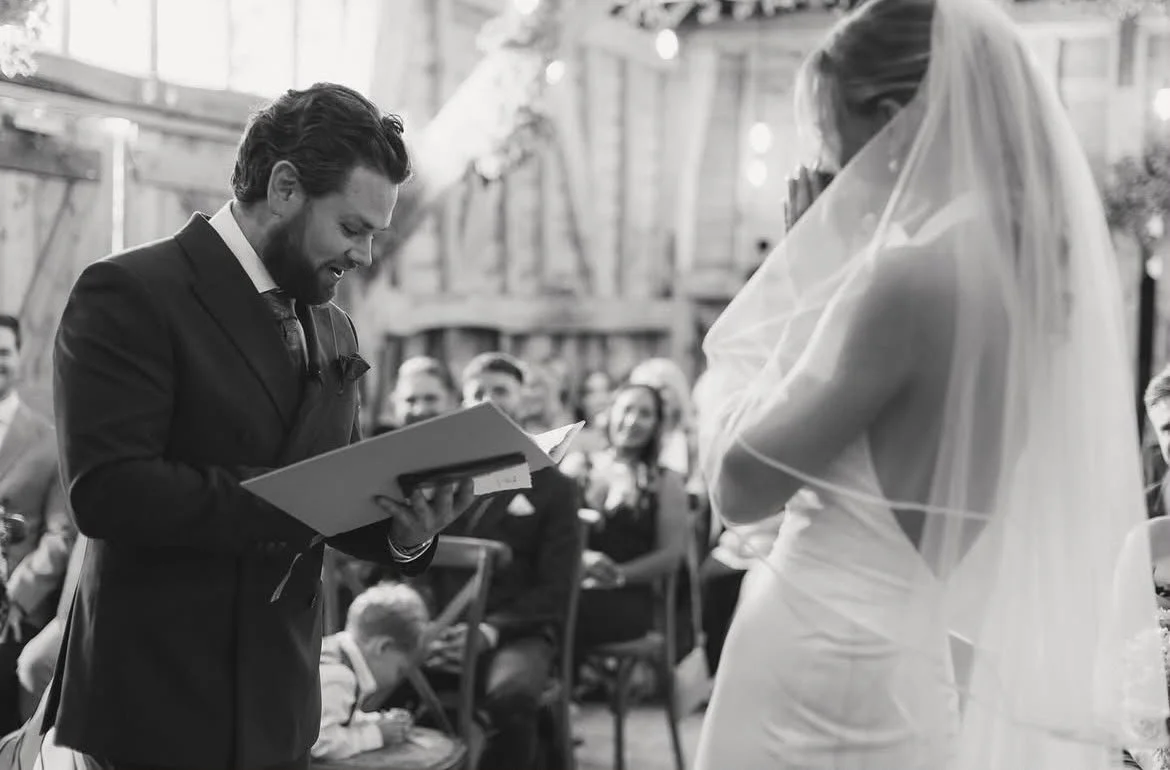 A couple celebrate their wedding ceremony at High Billinghurst Farm, led by an independent Surrey wedding celebrant, creating a relaxed and personalised celebration with family and friends. Photo: Leanne Peacock Photography
