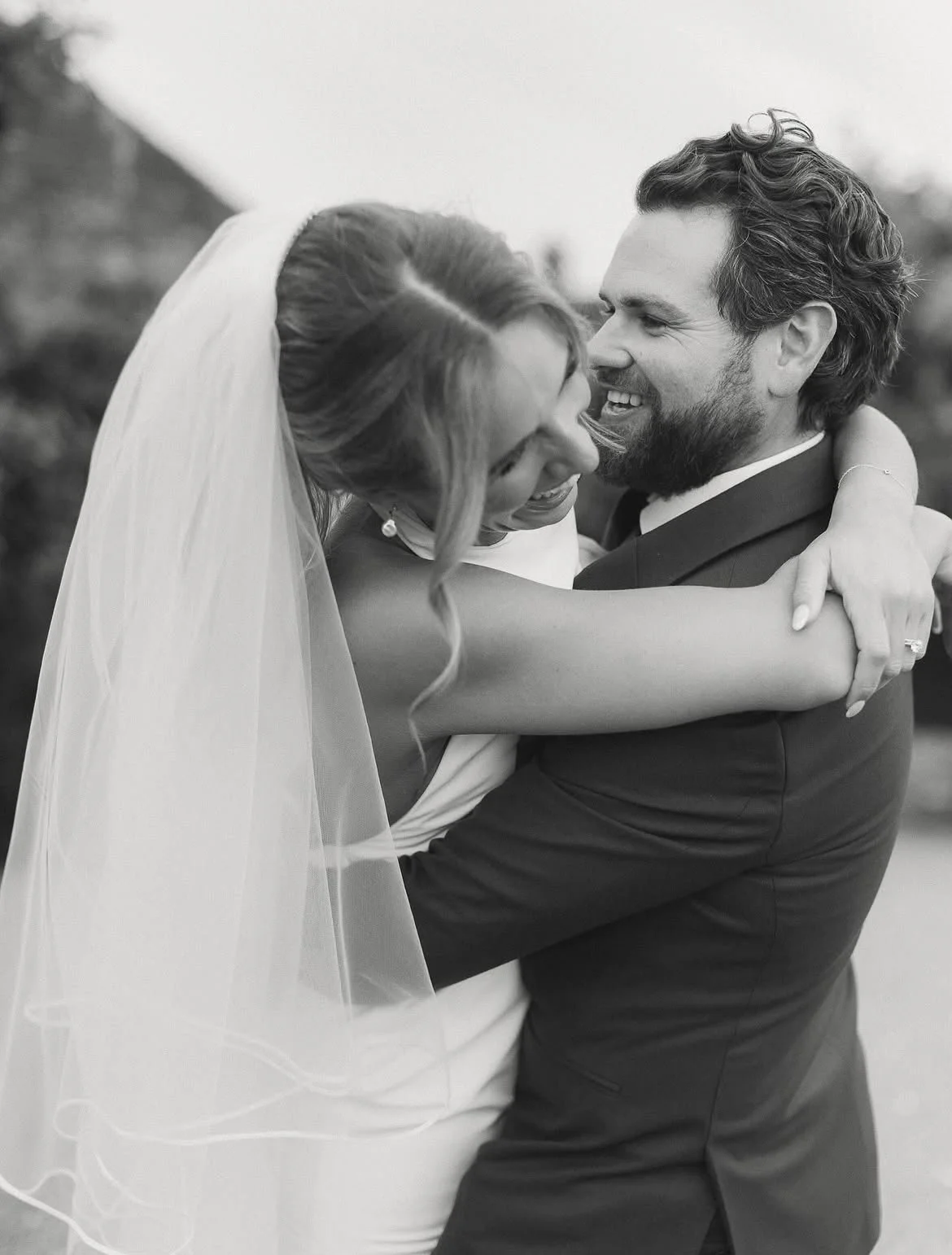 Bride and groom embrace to celebrate their wedding ceremony at High Billinghurst Farm in Surrey, led by an independent wedding celebrant. Photo: Leanne Peacock Photography