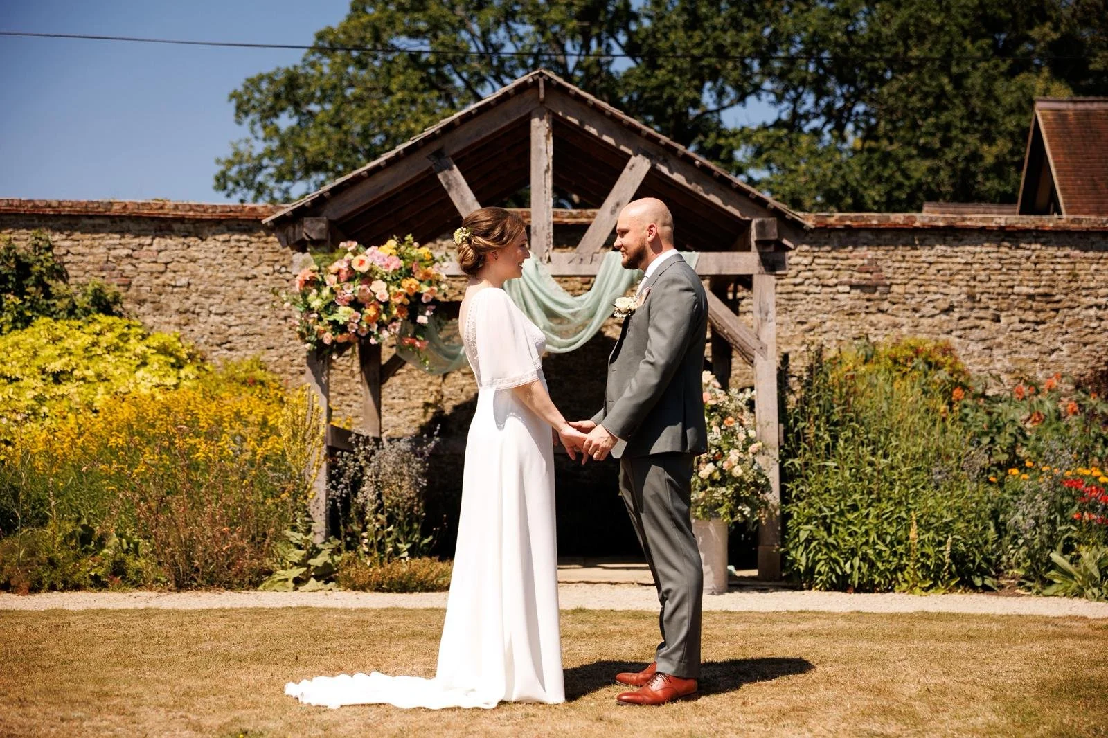 Couple during personalised wedding ceremony led by Surrey Wedding Celebrant at Loseley Park. Guildford Wedding Venue, Photo: Laura Ellen 