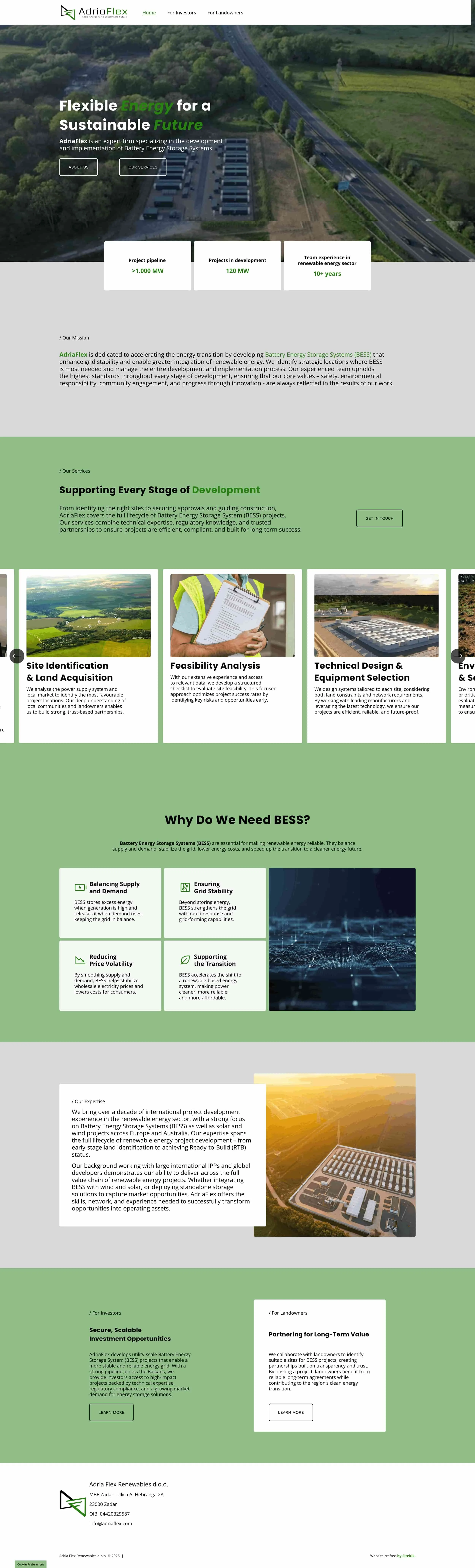 Aerial view of a renewable energy company's facility surrounded by green fields and trees, with roads nearby