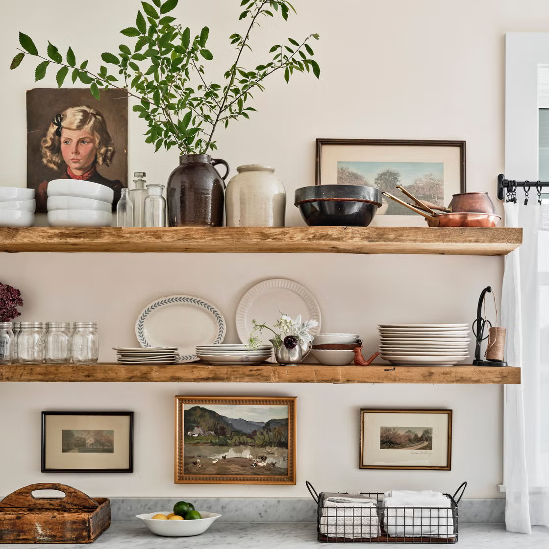 A decorated set of rustic wooden farmhouse wall shelves stacked with traditional dishware.