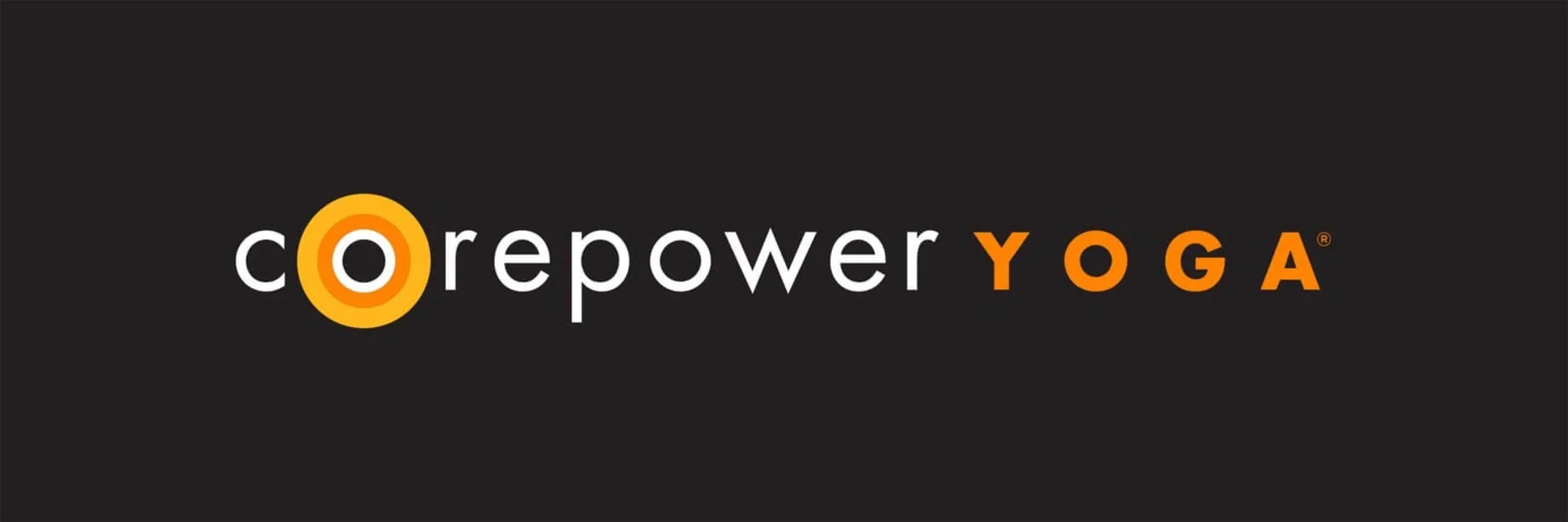 Logo for Corepower Yoga with black background, white and orange text.