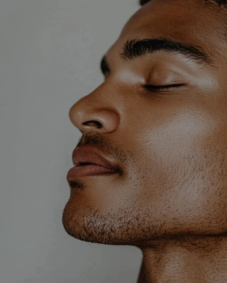 Close-up side profile of a man with smooth, glowing skin and relaxed expression, representing men’s facial treatments and skincare services at The Lab Co Toronto.