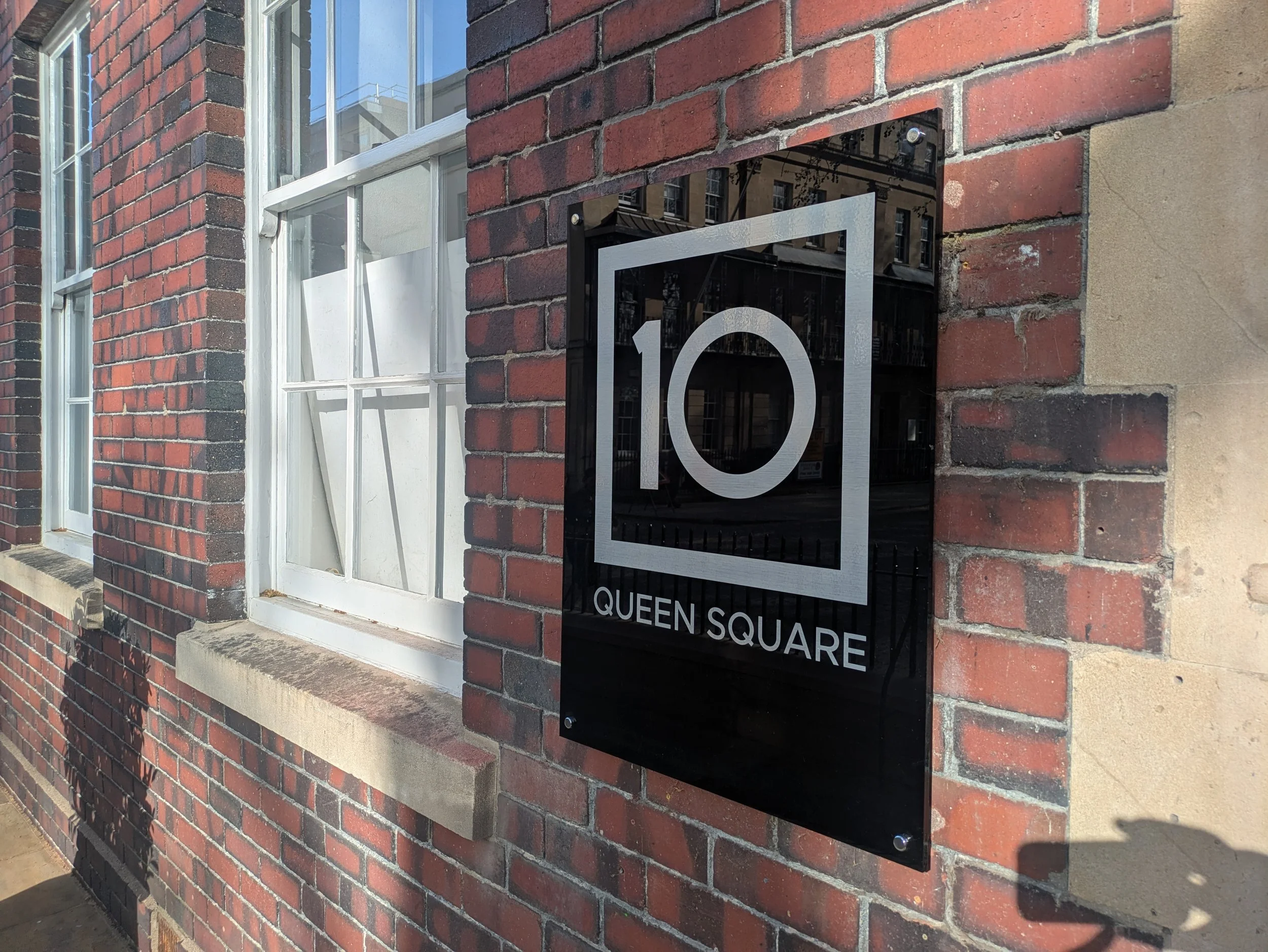 10mm gloss acrylicn panels with Brushed silver self-adhesive vinyl. Secured with stand-off locators