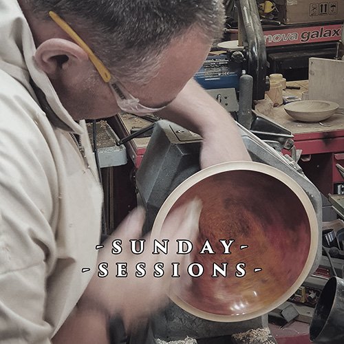 Four metal chisels with different blade shapes and sizes standing upright on a surface.