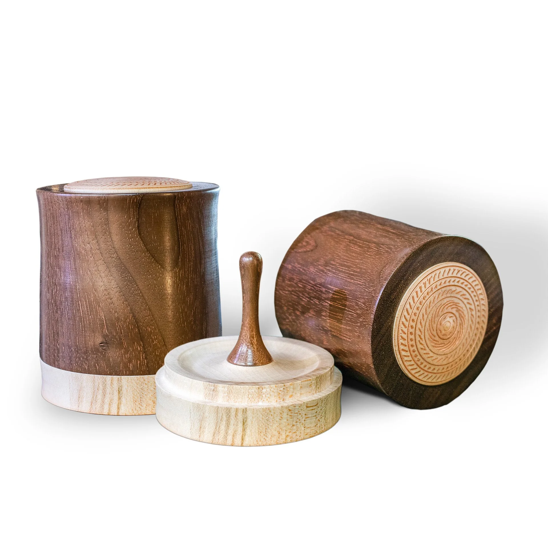 Two wooden drums and a wooden spinning top toy placed on a plain white background.