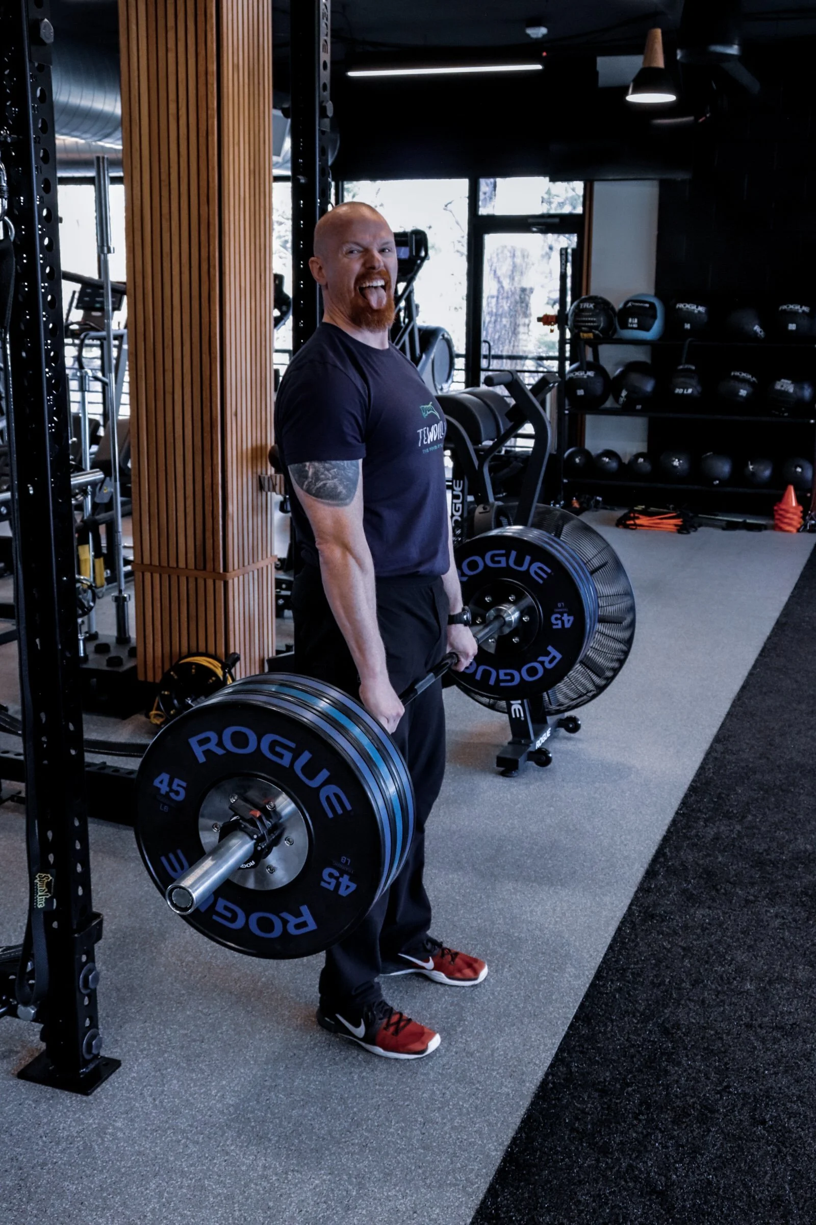 Shaun Cook, owner of Crucible Strength, showing his clients his favorite strength exercise.