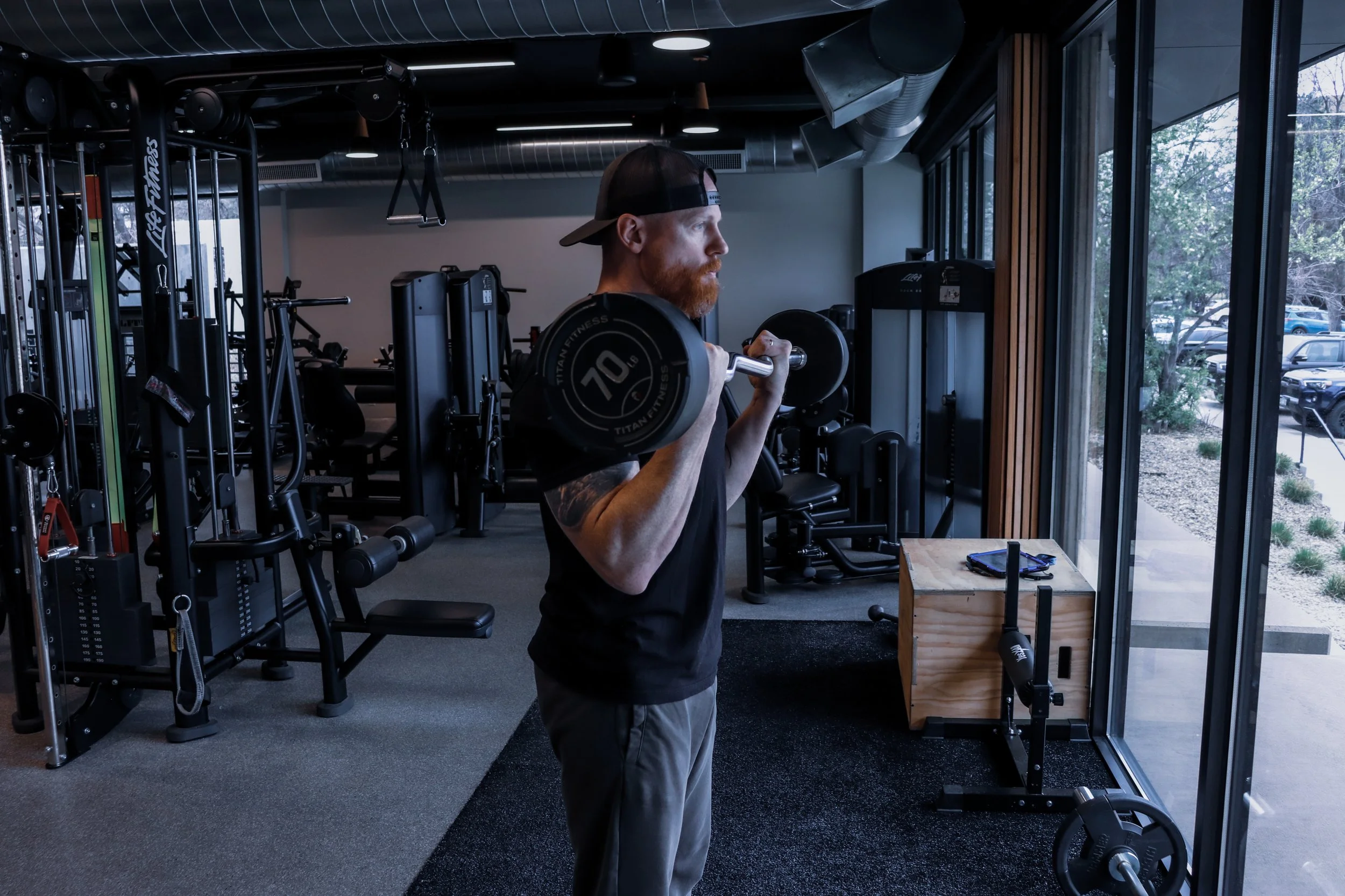 Personal trainer, Shaun Cook, demonstrates a strength exercise to his clients.