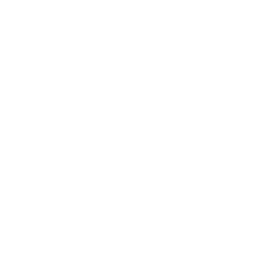 person wearing a white helmet and safety harness performing maintenance on a wind turbine against a clear blue sky