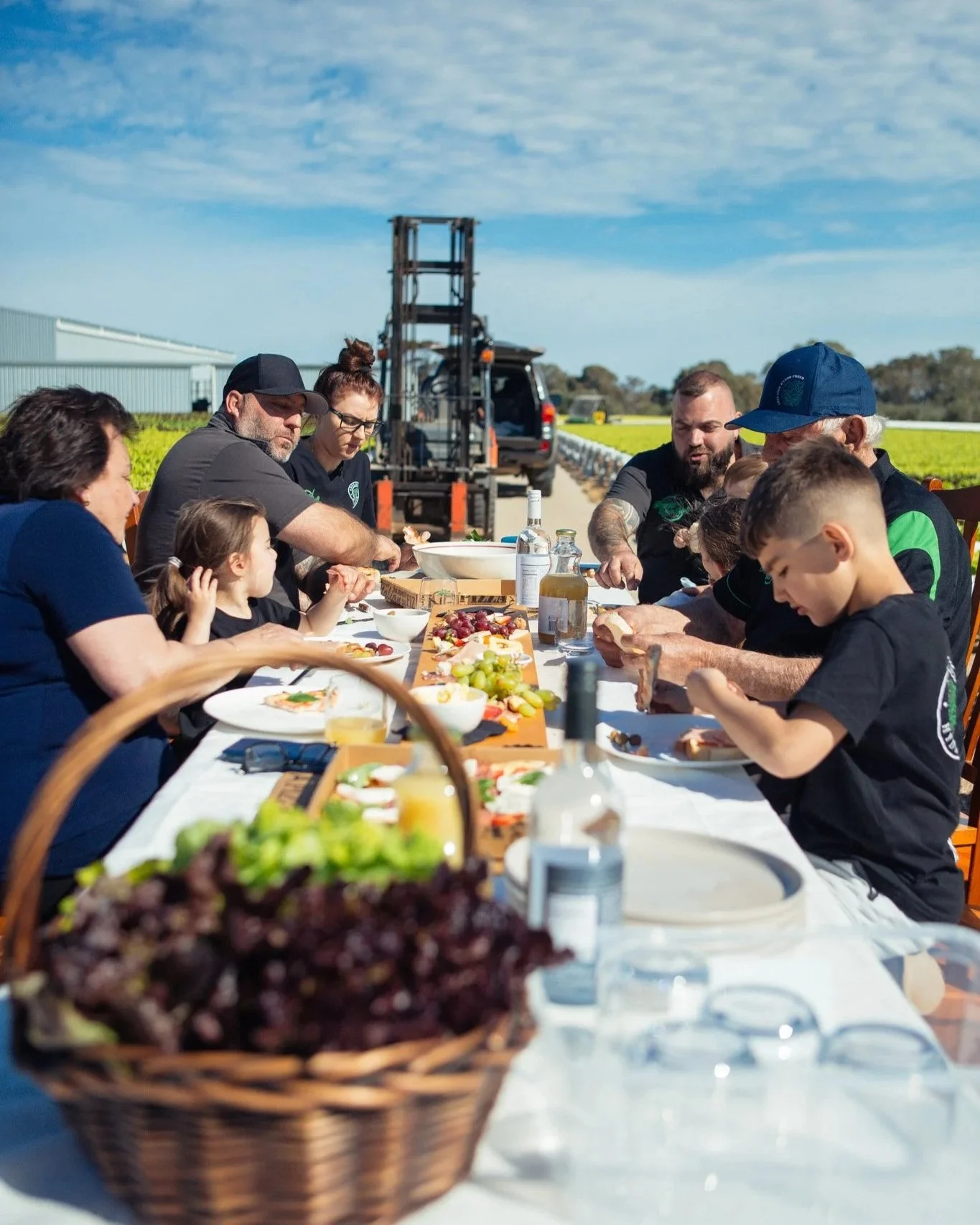 Adelaide Hydro Fresh family around a long outdoor table enjoying a meal.
