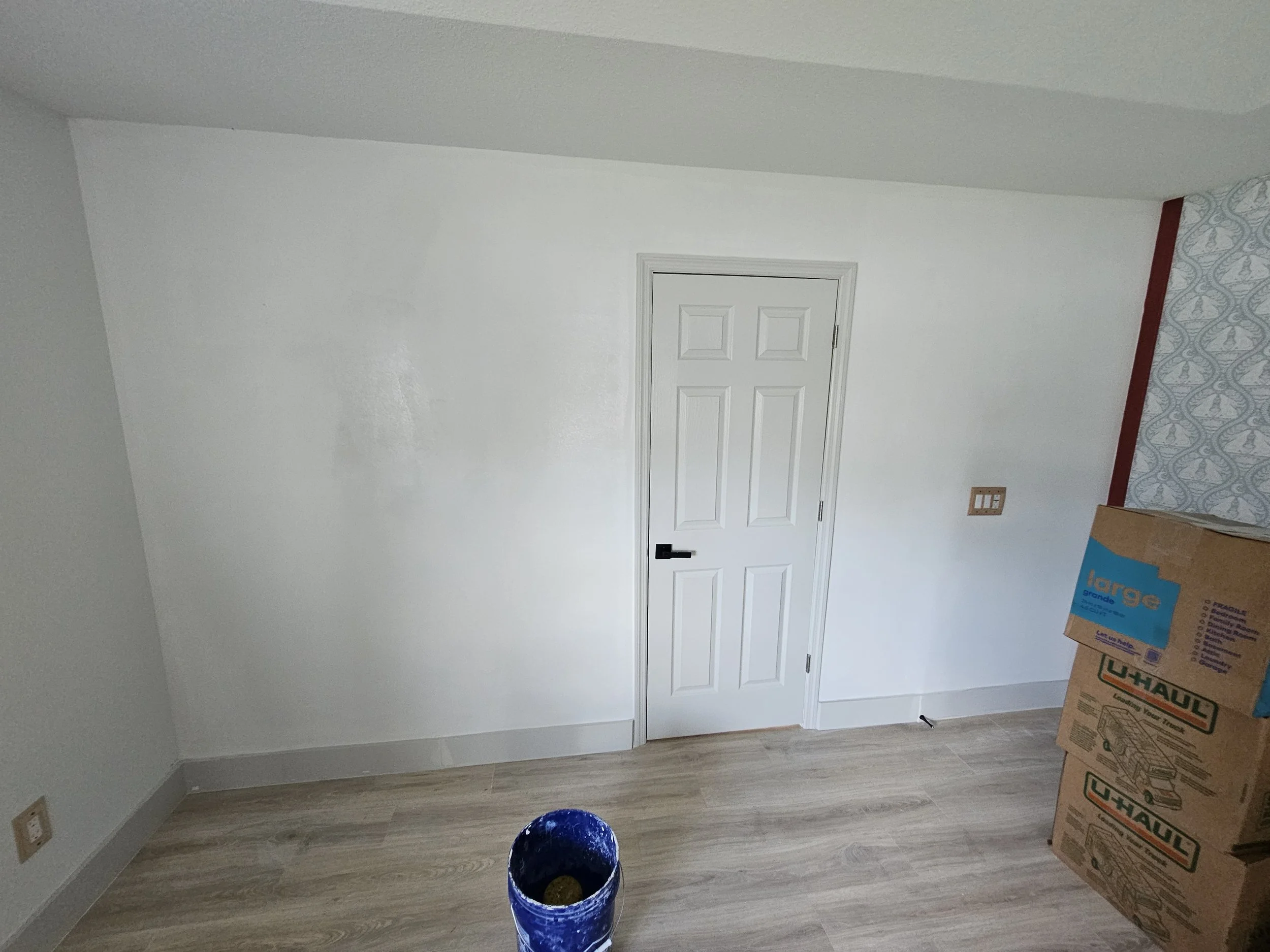 Interior room in Palm Coast after framing, installing drywall, taping, mudding, painting, and installing a door for the home owners new home office.