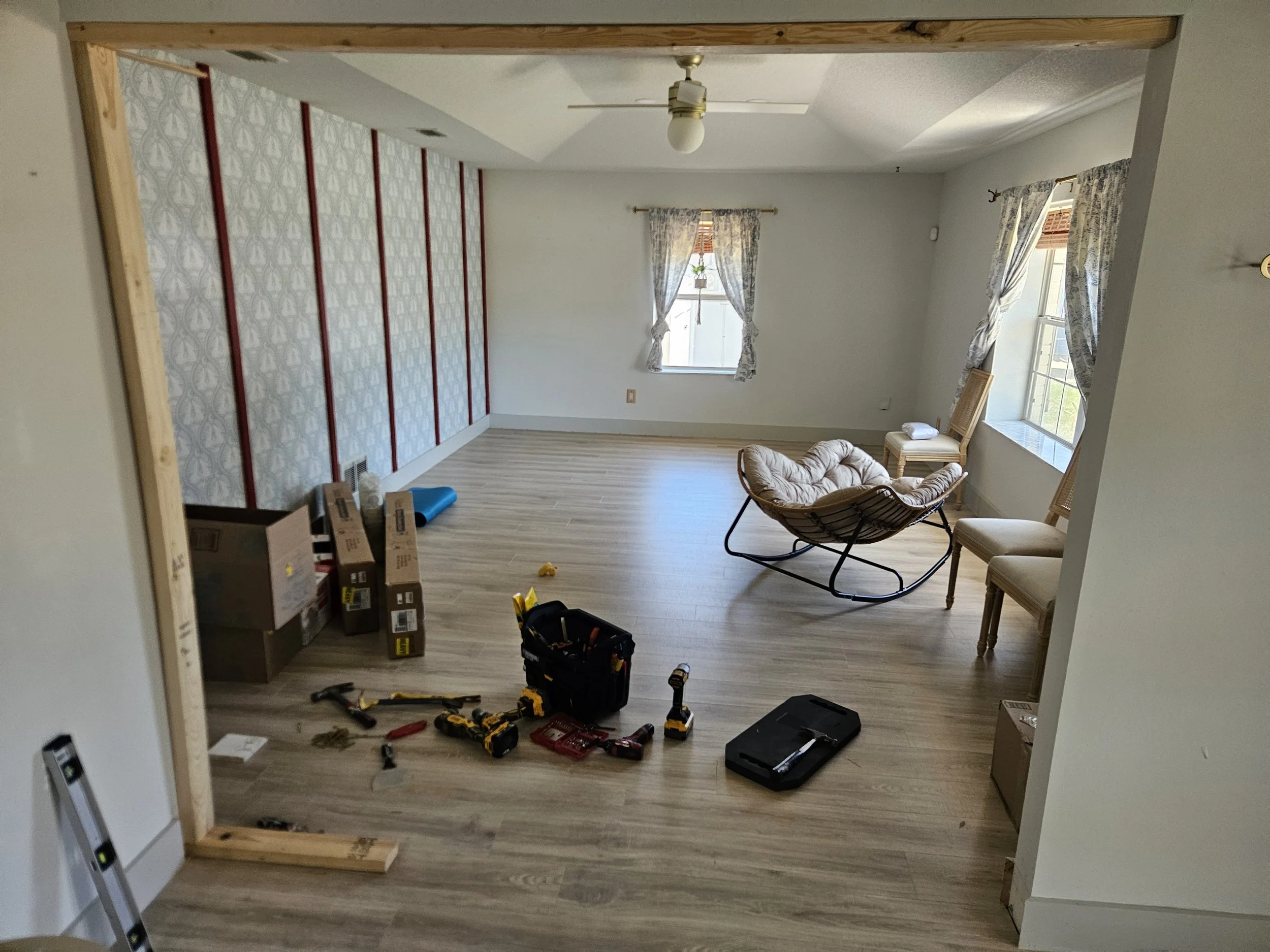 Custom renovation to install framed wall and door where previously doorway was open.
