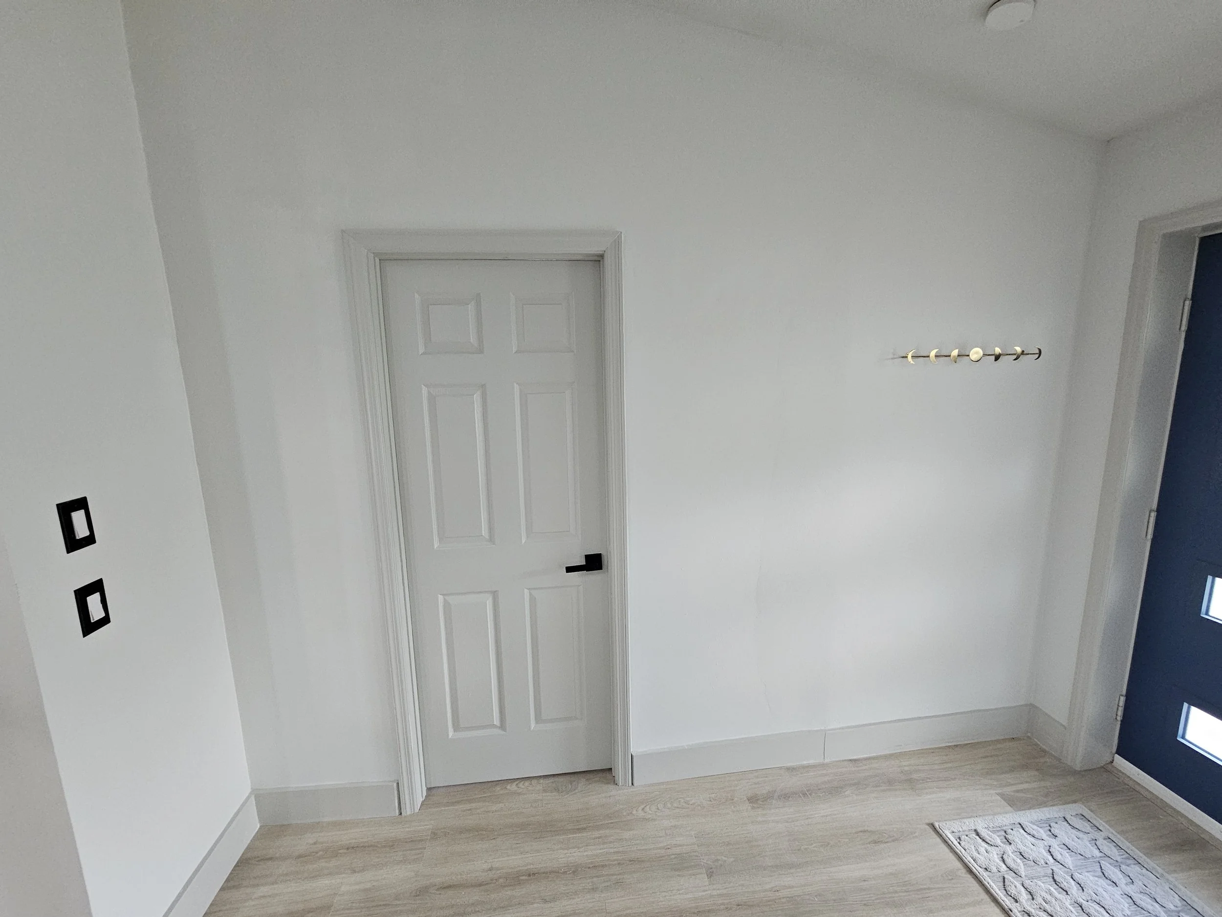 Interior room in Palm Coast after framing, installing drywall, taping, mudding, painting, and installing a door for the home owners new home office.