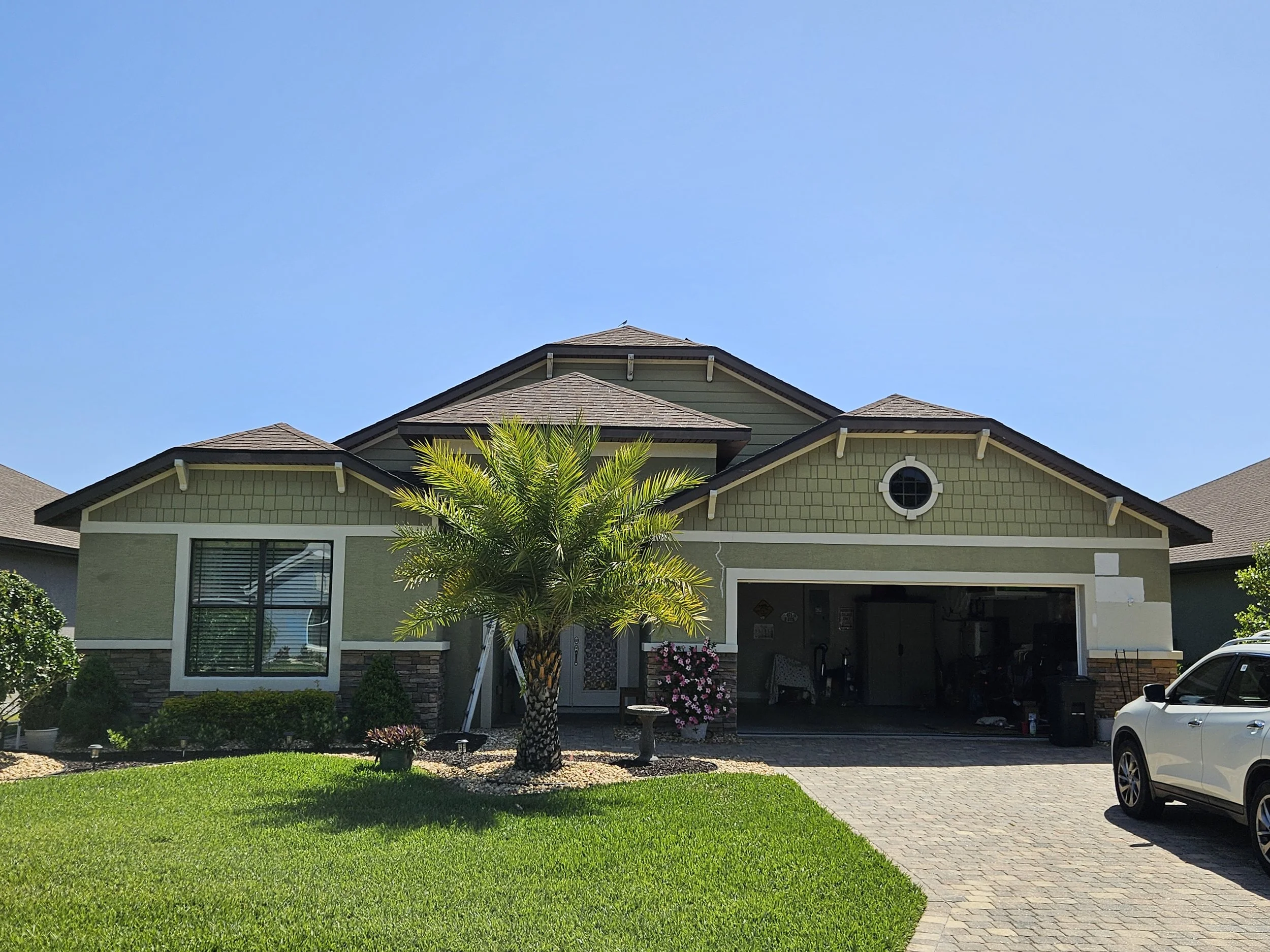Home in Ormond Beach before we primed and painted exterior with Sherman Williams emerald rain refresh.