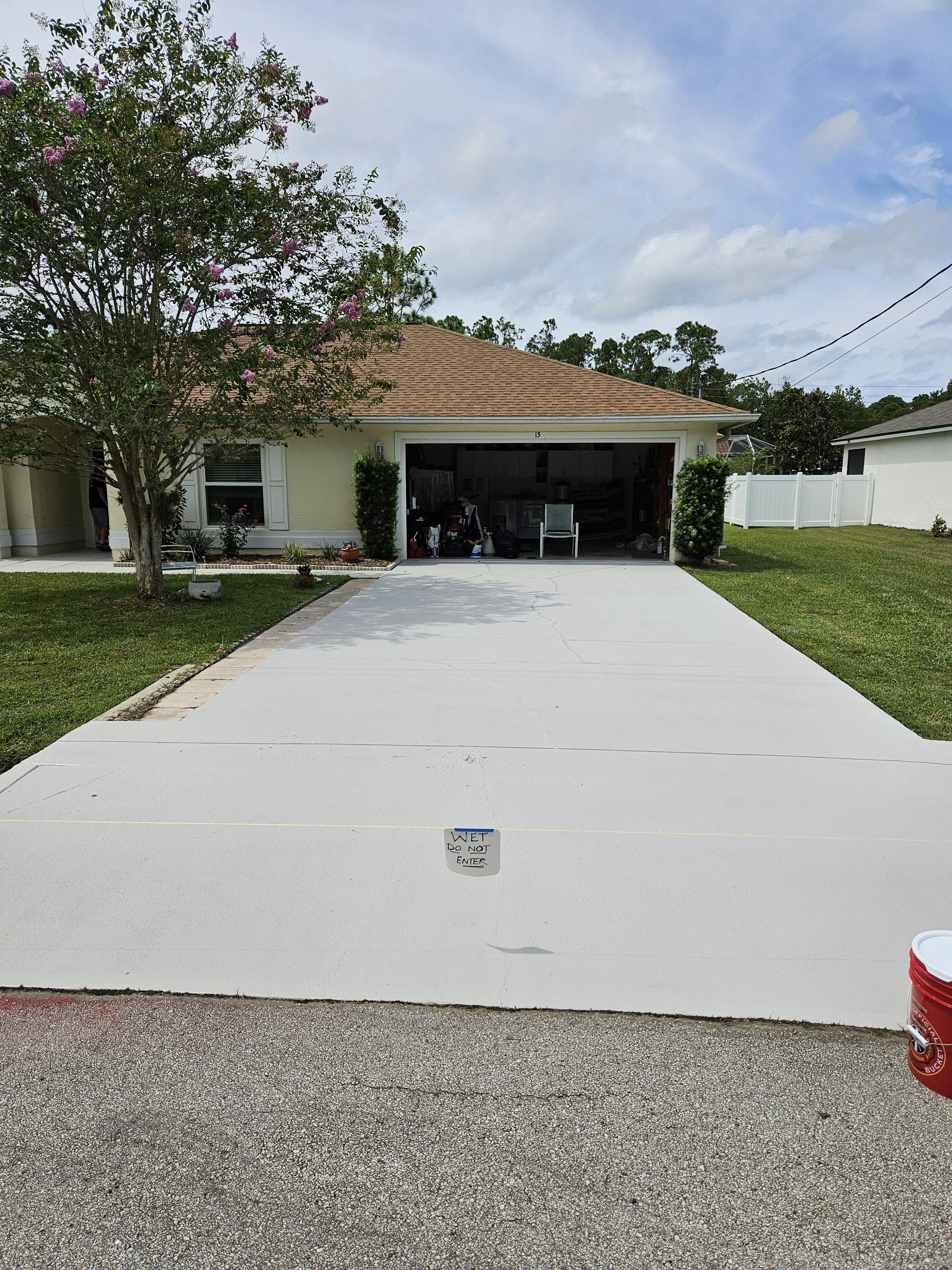 Palm Coast home after finished pressure washing and painting their driveway.