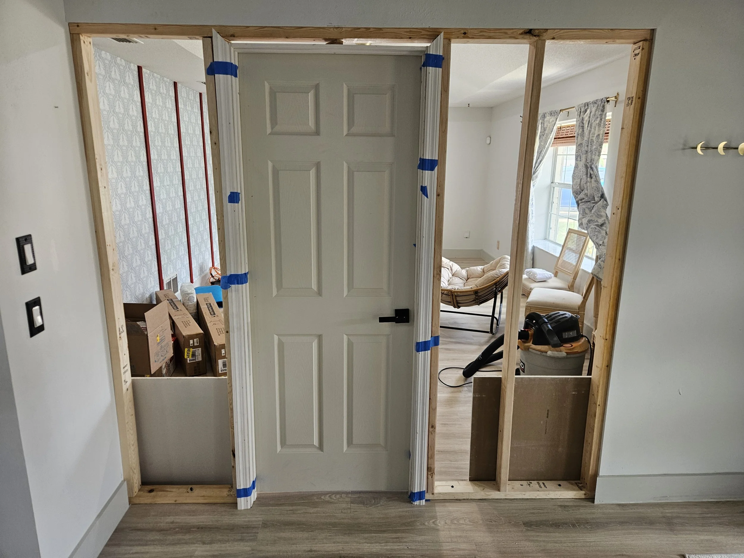 Door/wall being installed on project to wall off opening in home for new office.