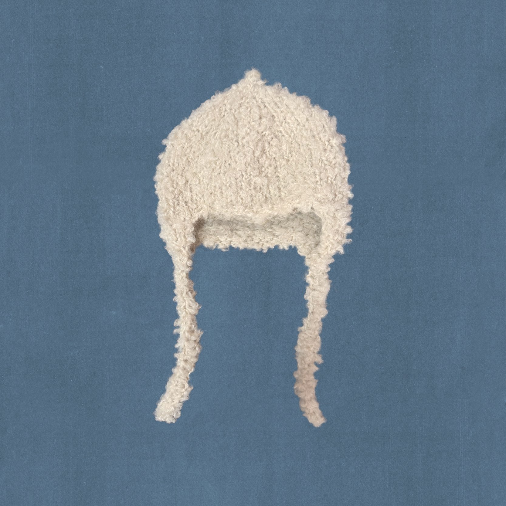 hand-knitted beige bonnet