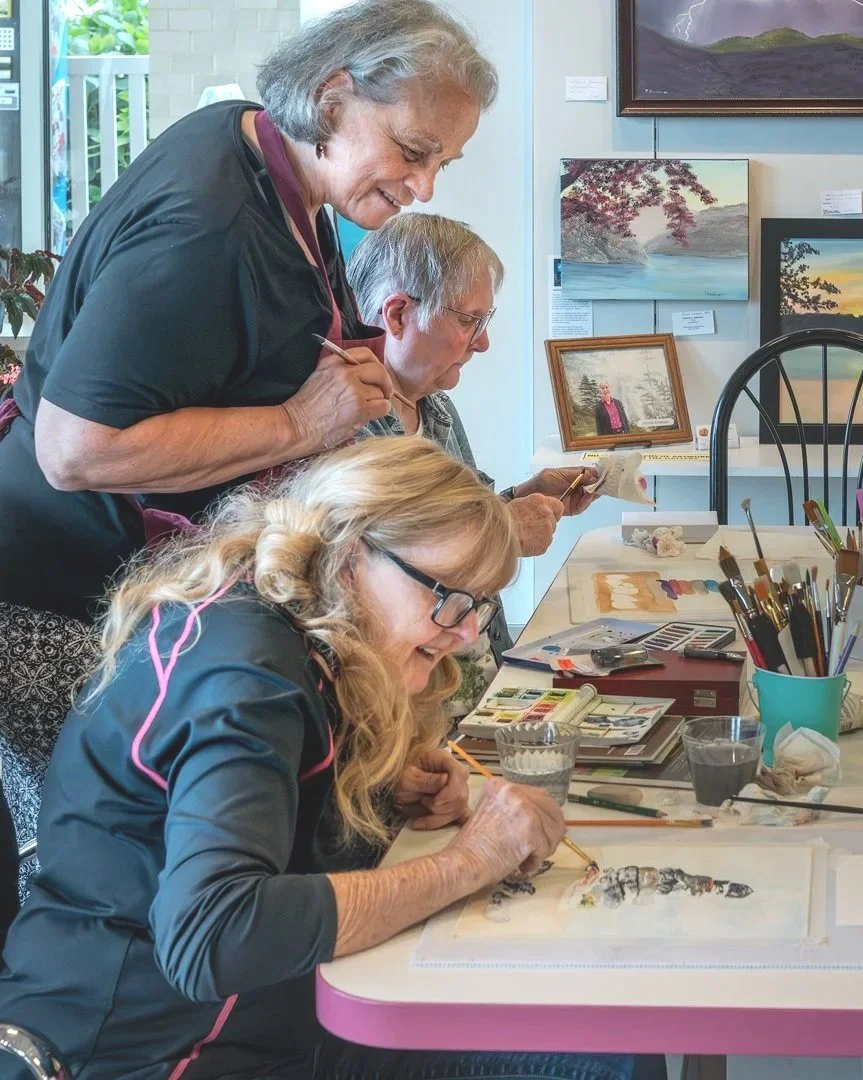 Stephanie McQuade teaching painting with watercolors in gallery