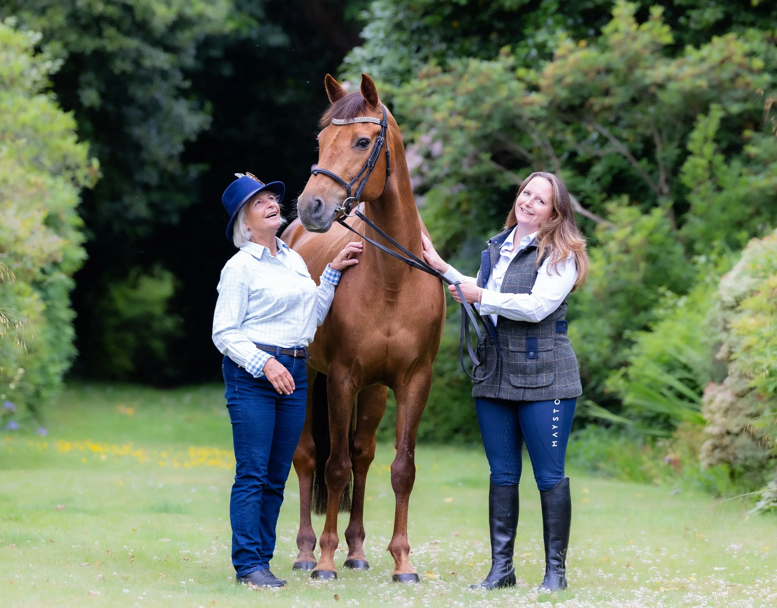 Mother and daughter with her horse in the garden