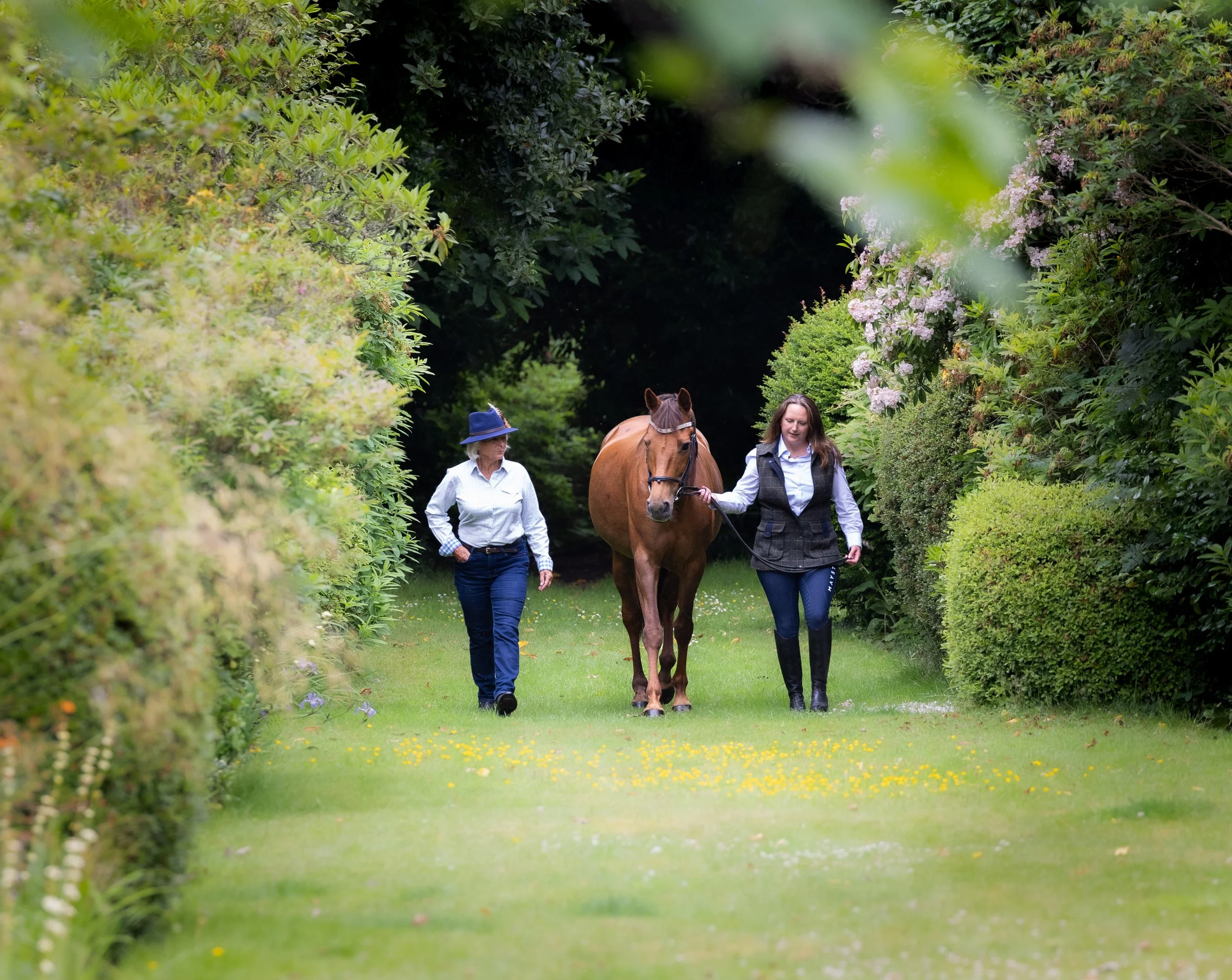 Mother and daughter with her horse in the garden