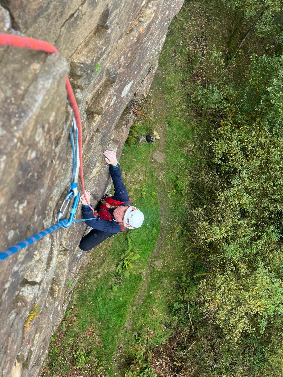 A client learning to second a trad rock climb