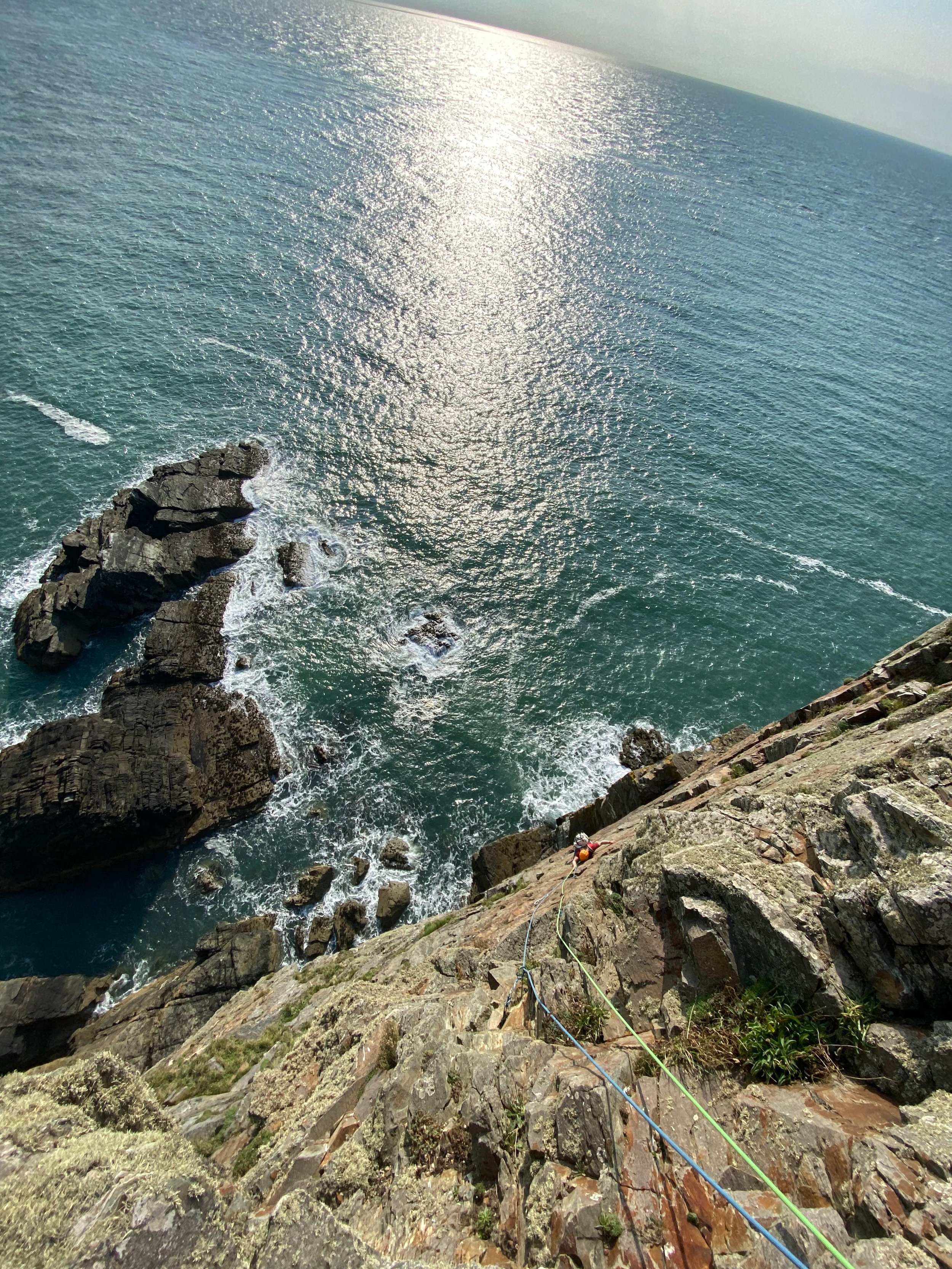 Sunset sea cliff climbing