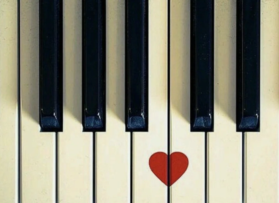 Up close shot of piano keys with a red heart
