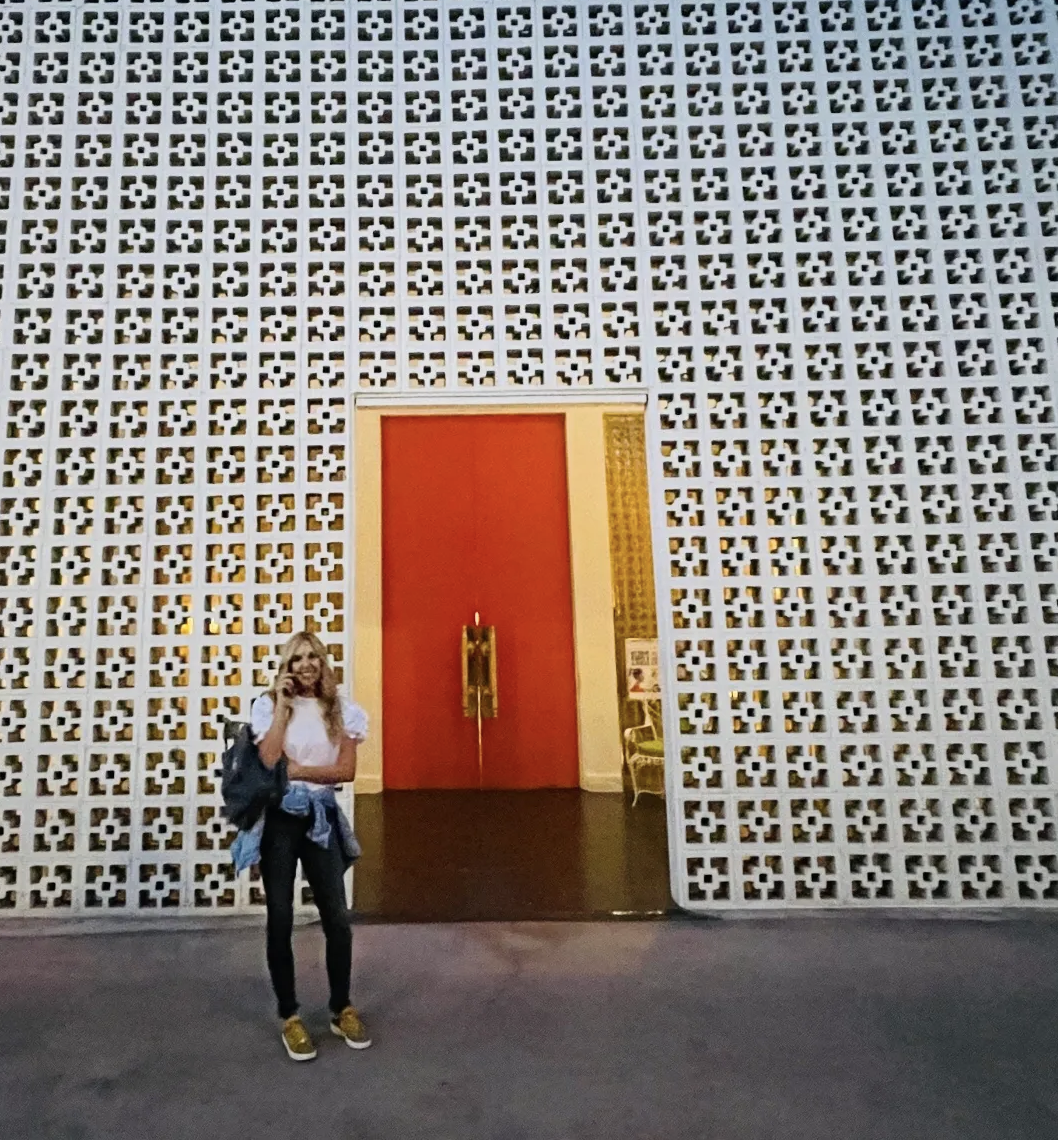 Traveling photo of Kirsten Nelson Telan in front of an ornate wall