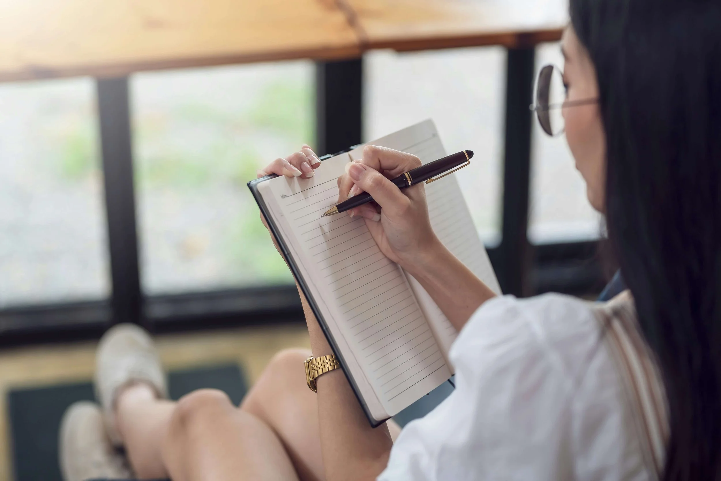 An author sketches ideas in a notebook