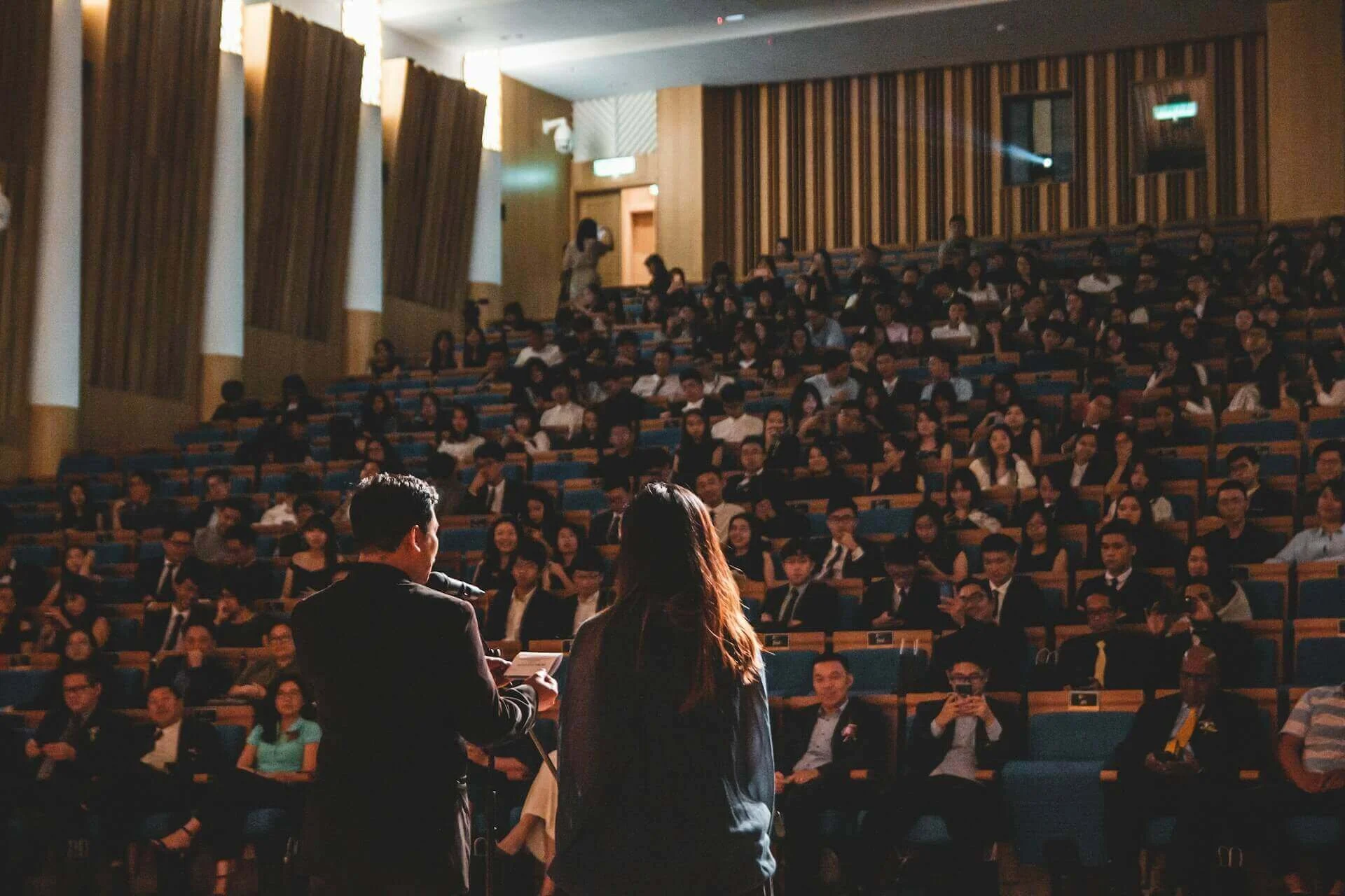 Two authors give a speech at a writing conference