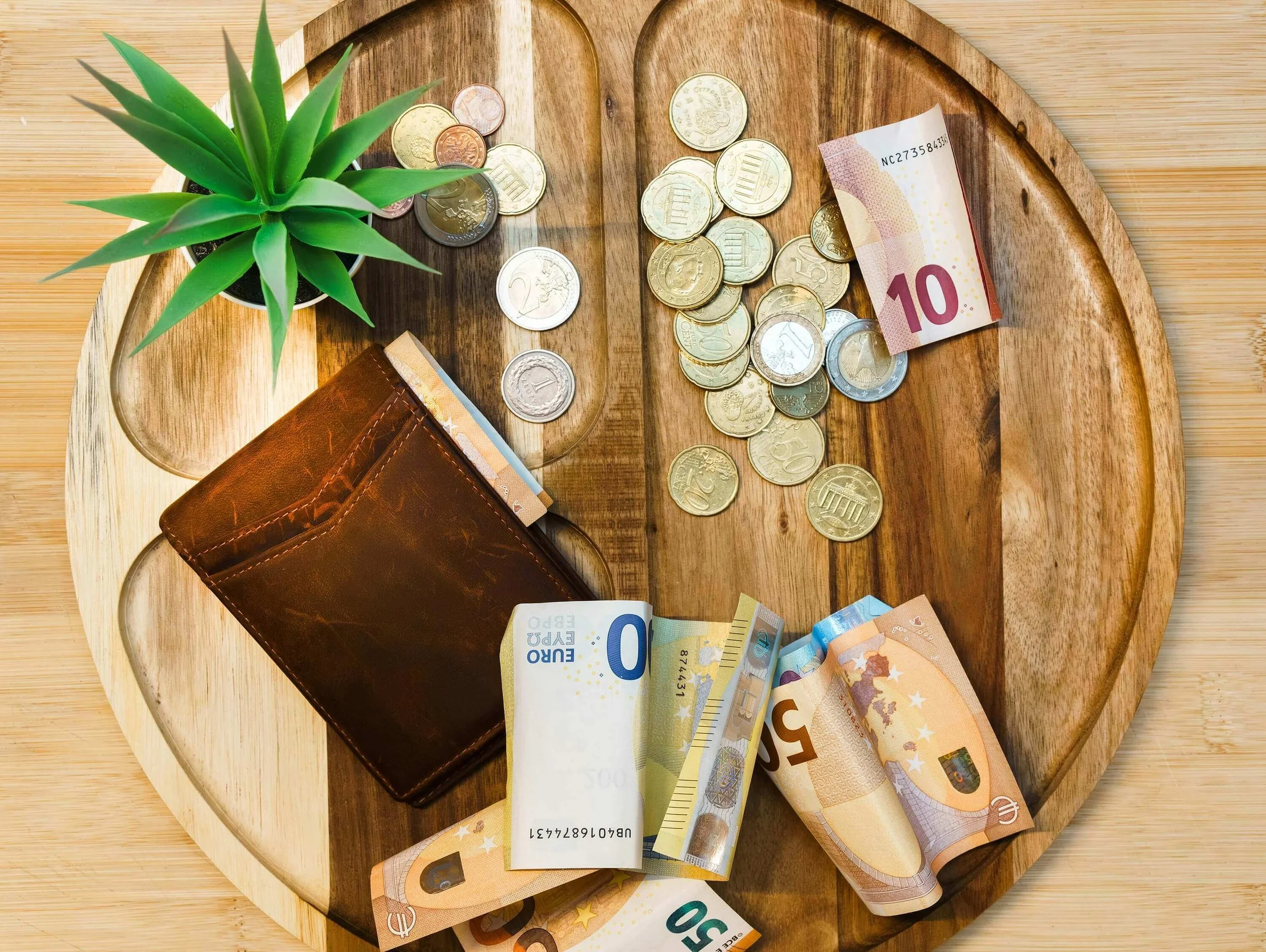 Money, coins, and a wallet stuffed with currency