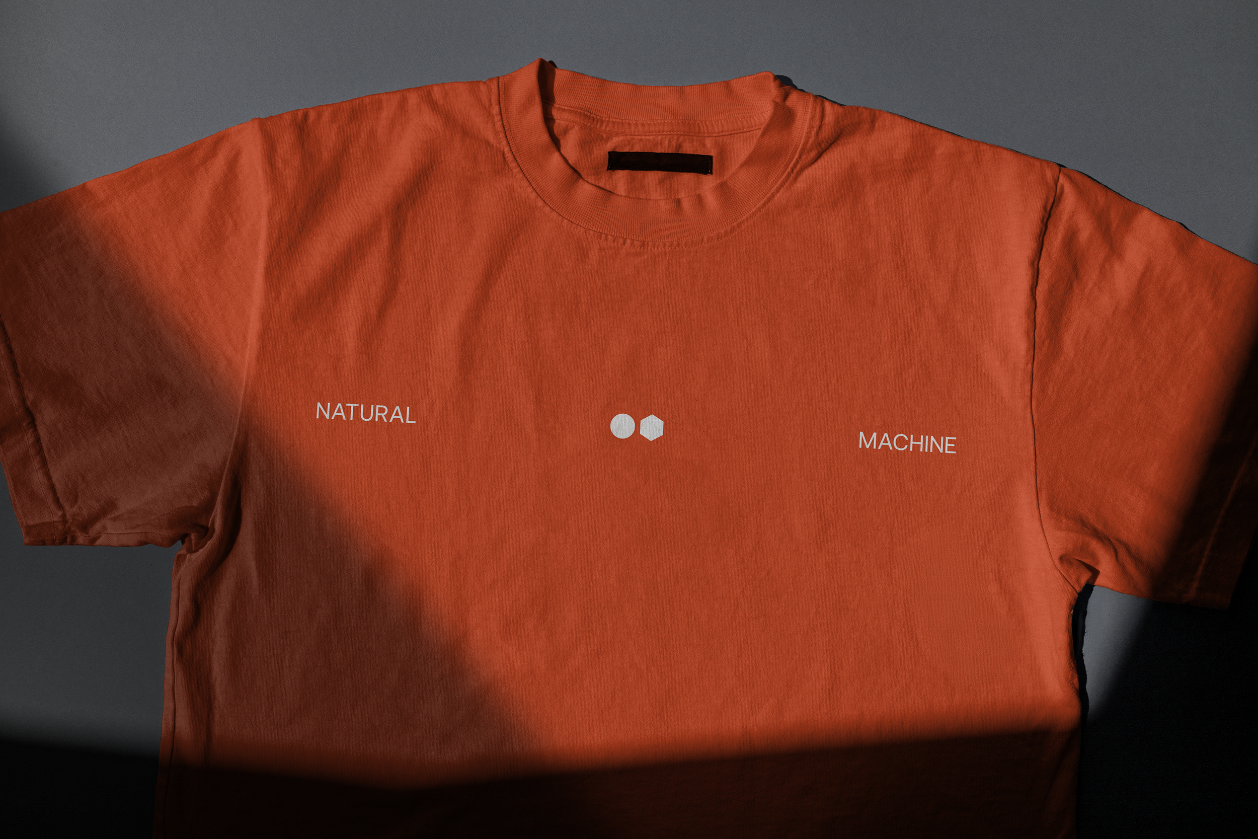 Natural Machine visual identity applied to a t-shirt.