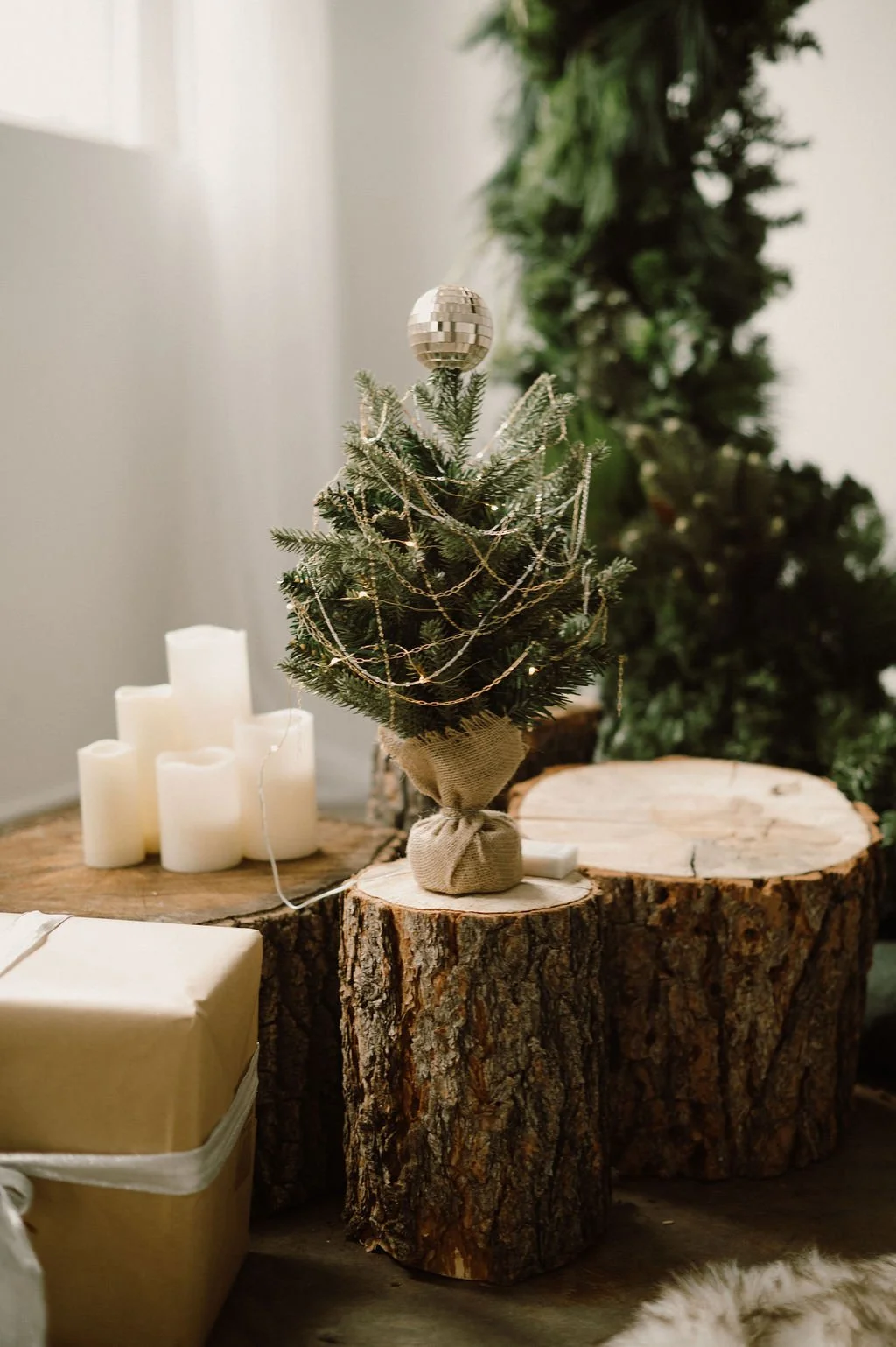 Holiday gift display with permanent jewelry chains draped on a miniature Christmas tree