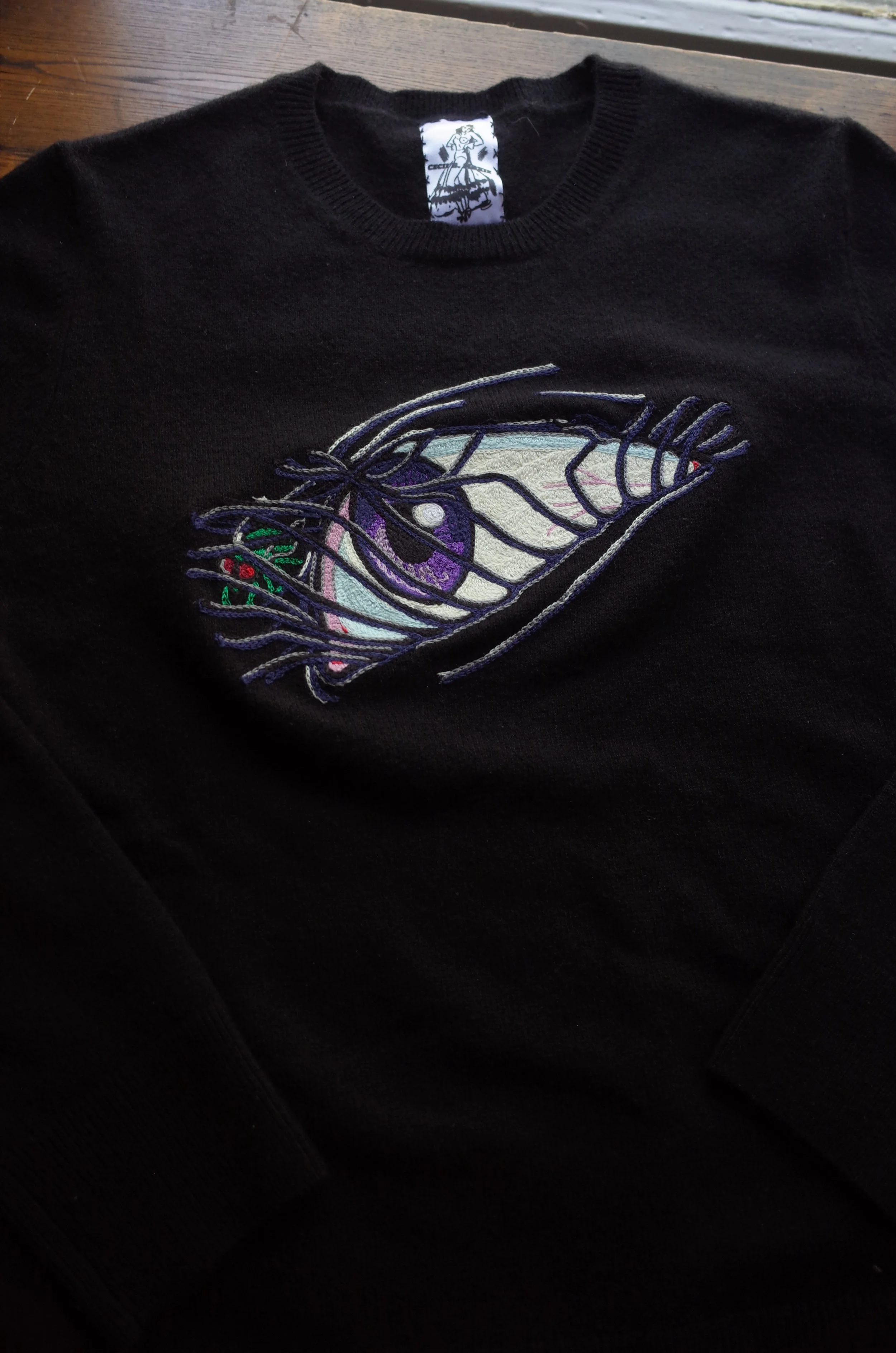 Black sweater with eye design embroidery