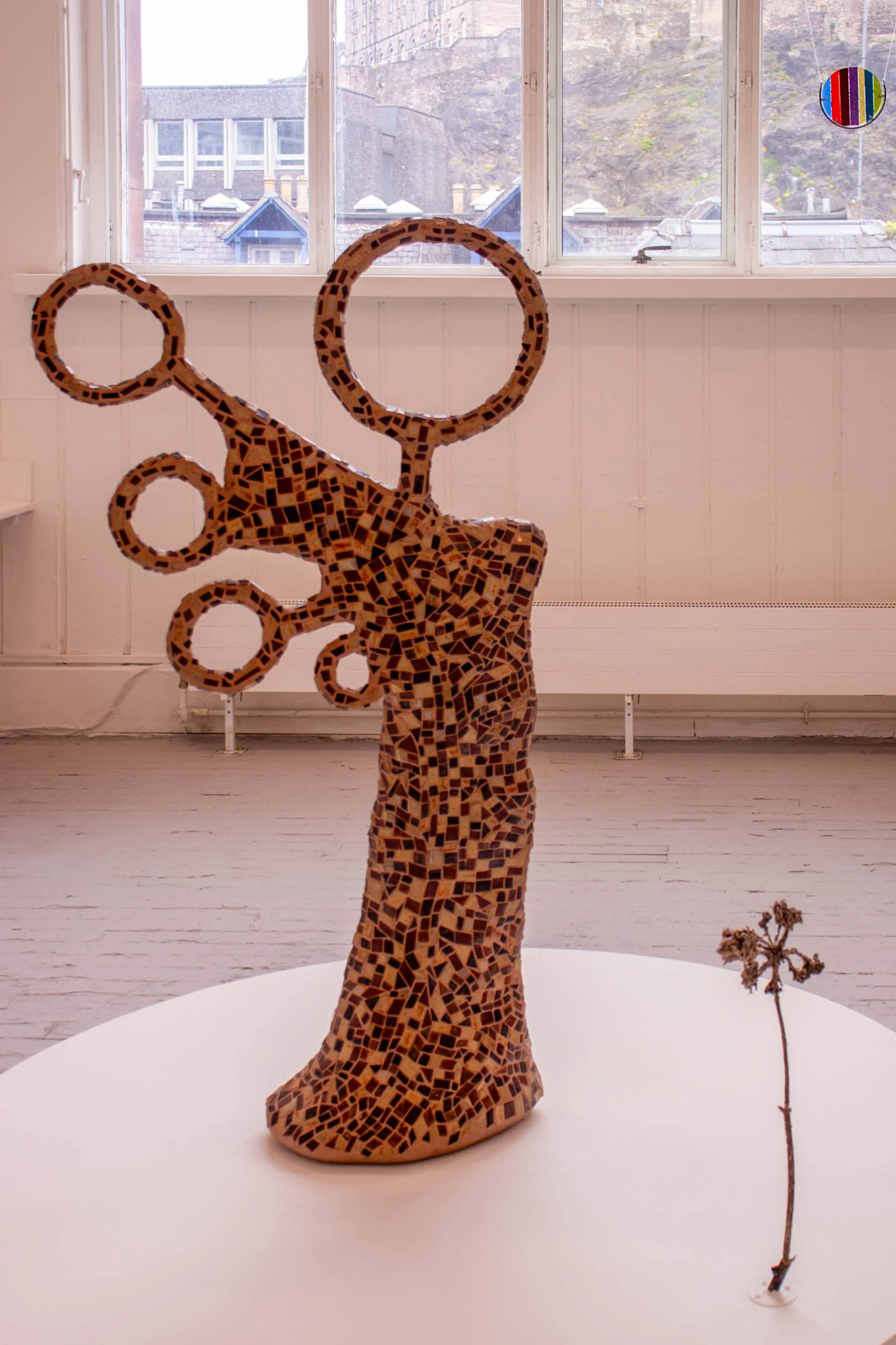 Mosaic with handmade ceramic tesserae (157 × 88 × 32 cm), bronze hogweed sculpture (60 × 16 cm).