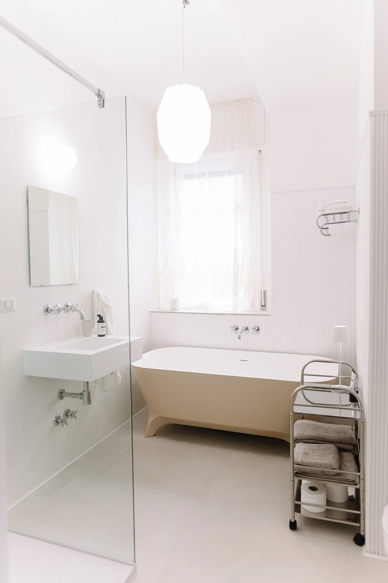 Bathroom with shower and bathtub in central Milan apartment