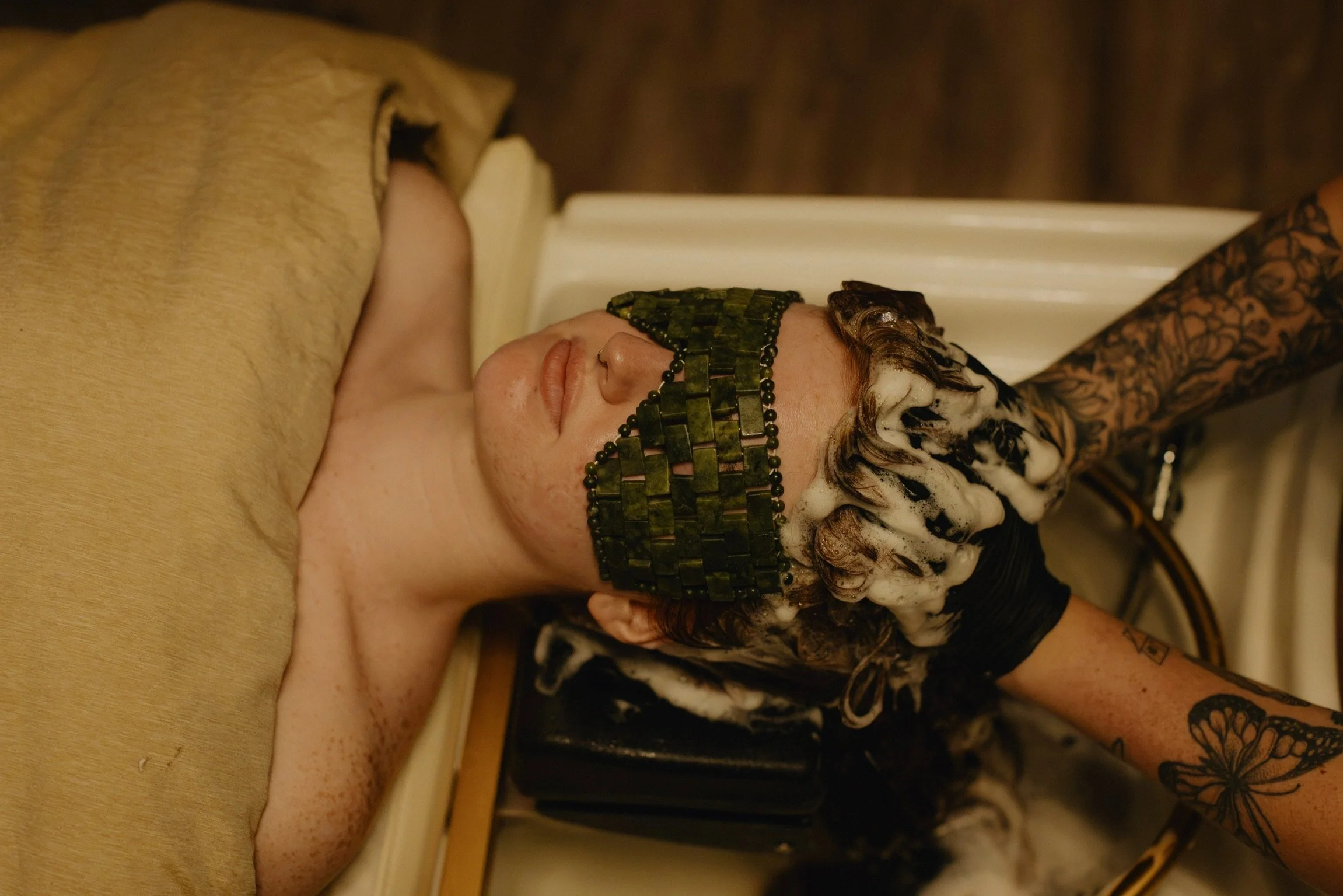 Client relaxing at the head spa with a water ring device during a scalp treatment at Nova Salon & Head Spa in Columbus, Ohio