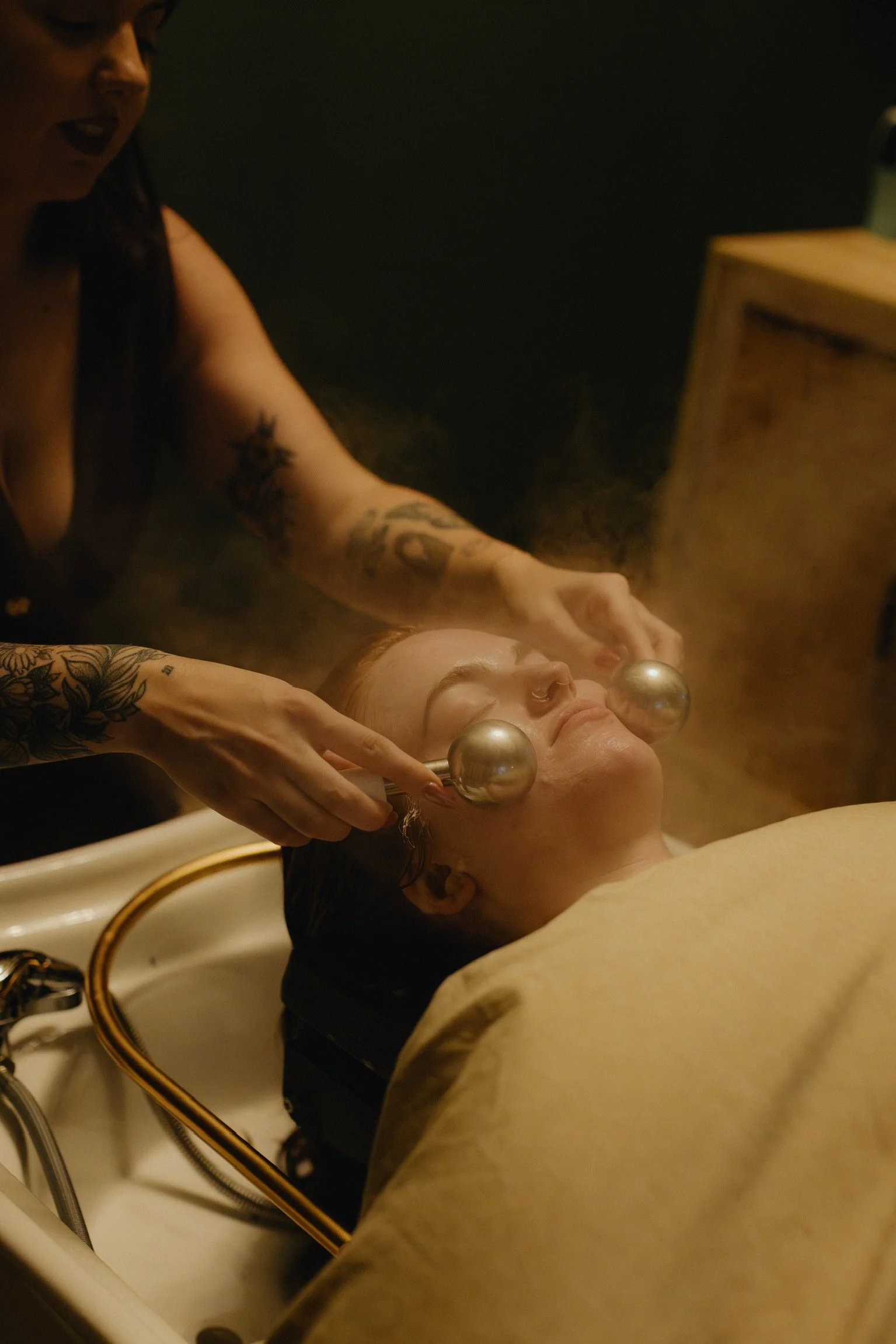 Close-up of a round brush and blowdryer styling hair during a professional blowout at Nova Salon & Head Spa in Columbus, Ohio.