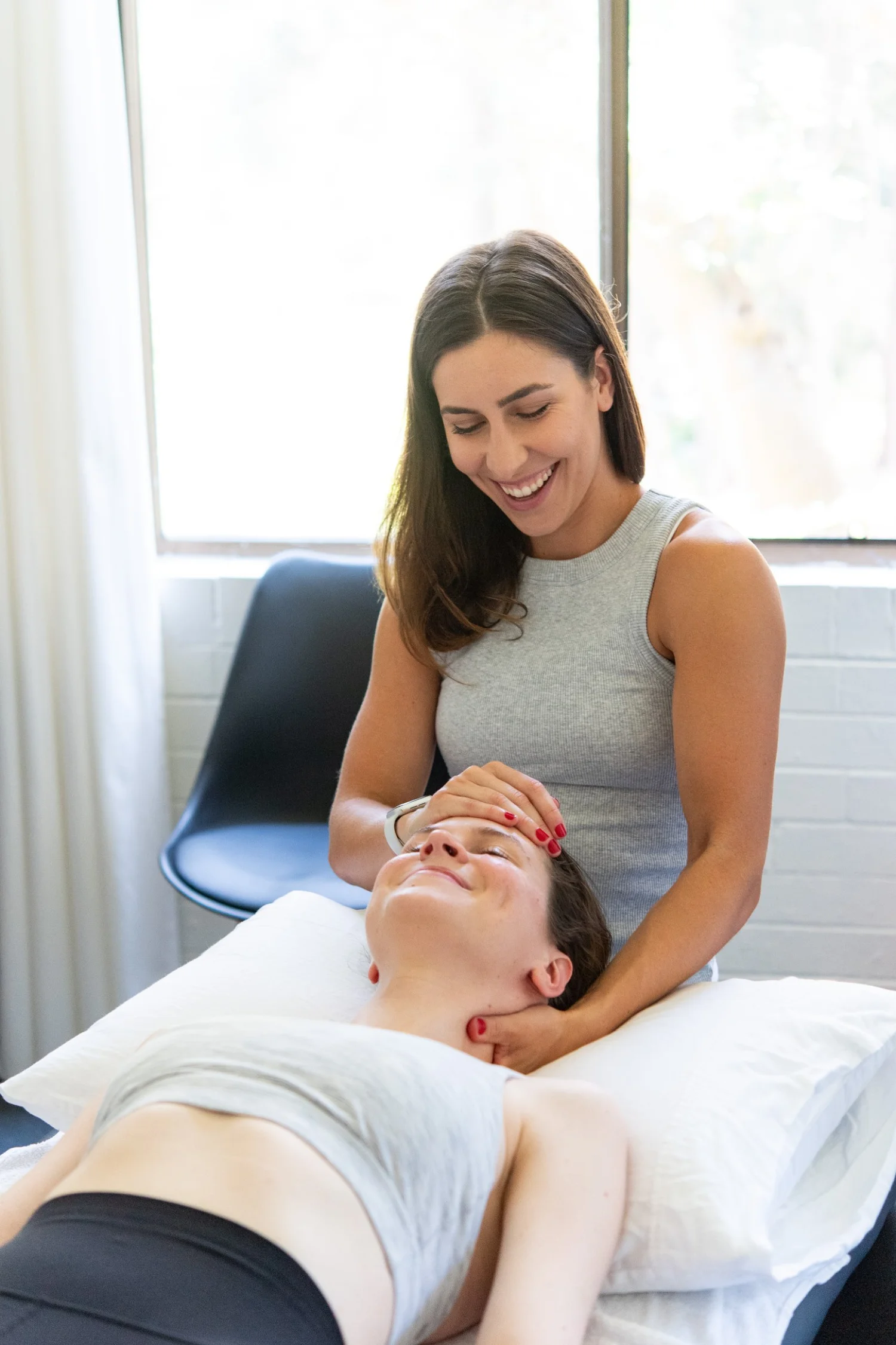 Physiotherapist treating a client's neck at Base Physiotherapy & Pilates, Drummoyne