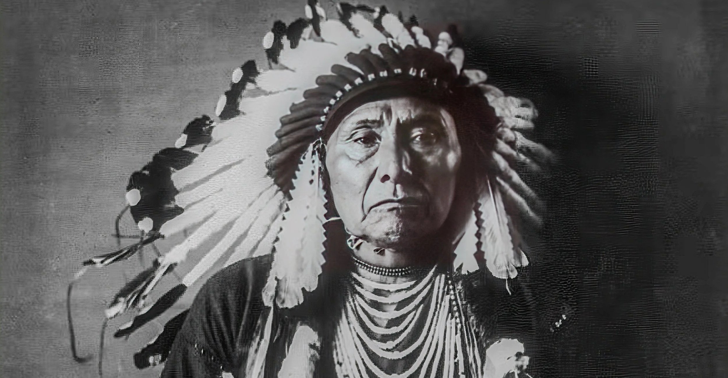 Black and white painting of an indigenous man wearing a traditional headdress with feathers, looking serious.