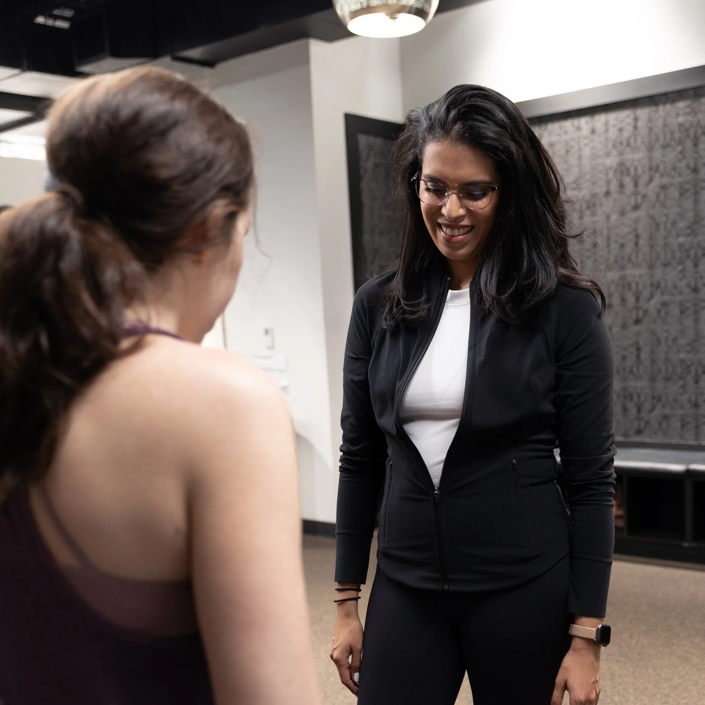 Physical therapist guiding a patient through rehabilitation exercises in NYC clinic