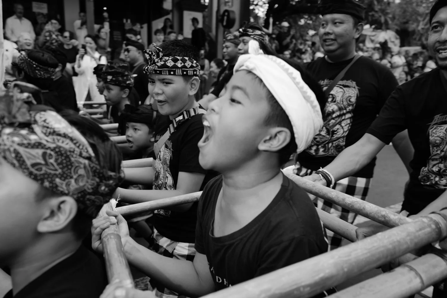 Children carrying an Ogoh-Ogoh procession frame through Ubud