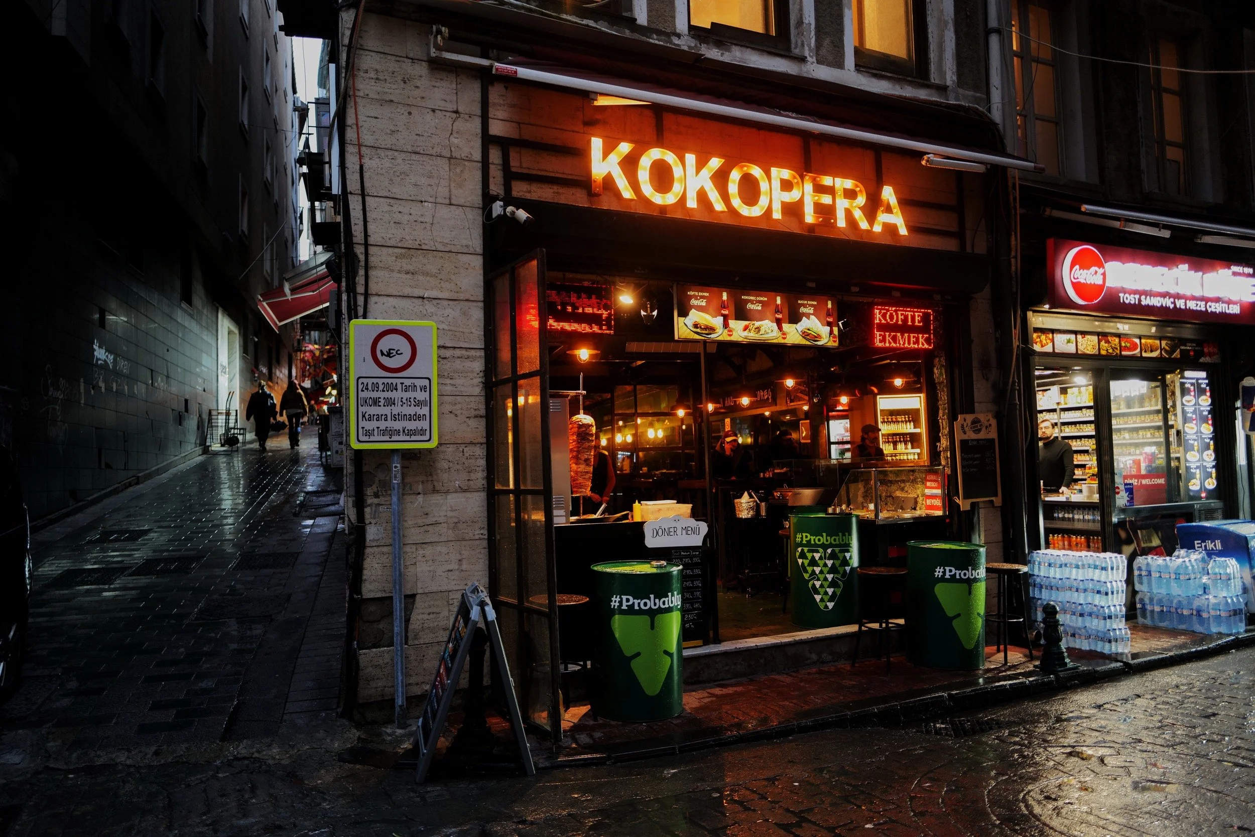 A lit street-food shop on a narrow Istanbul street