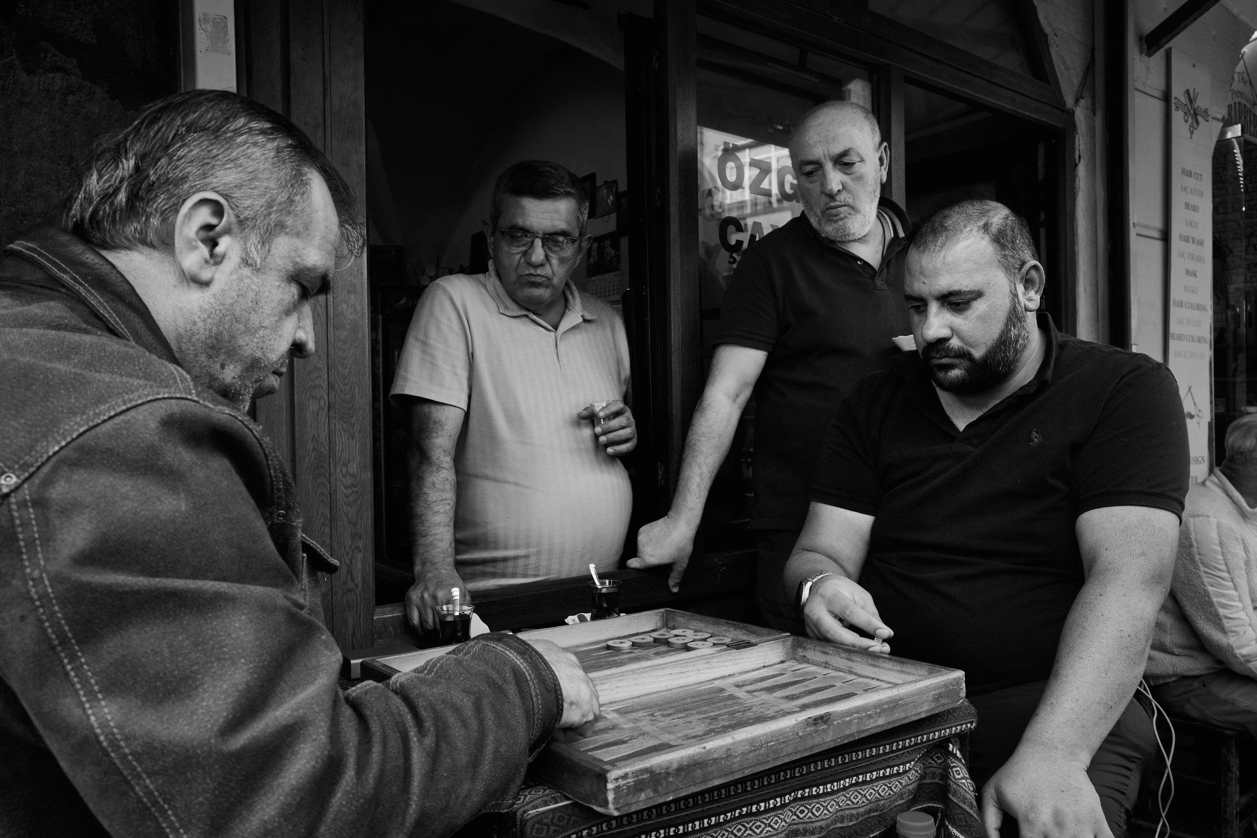 Men gathered around a backgammon game