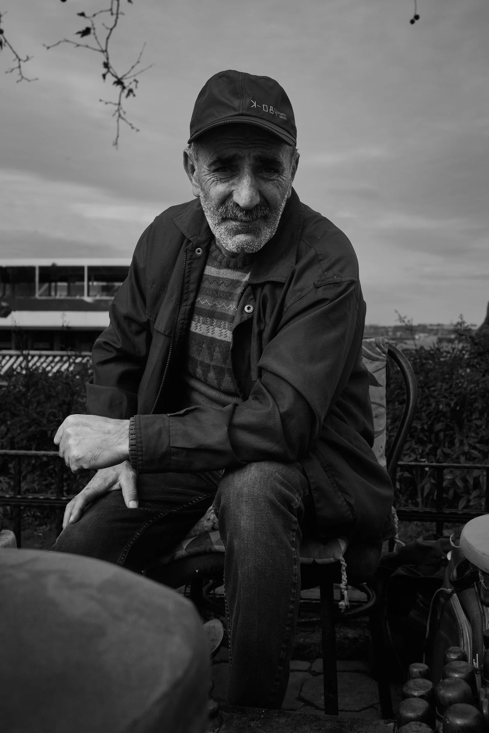 An older man seated by the waterfront
