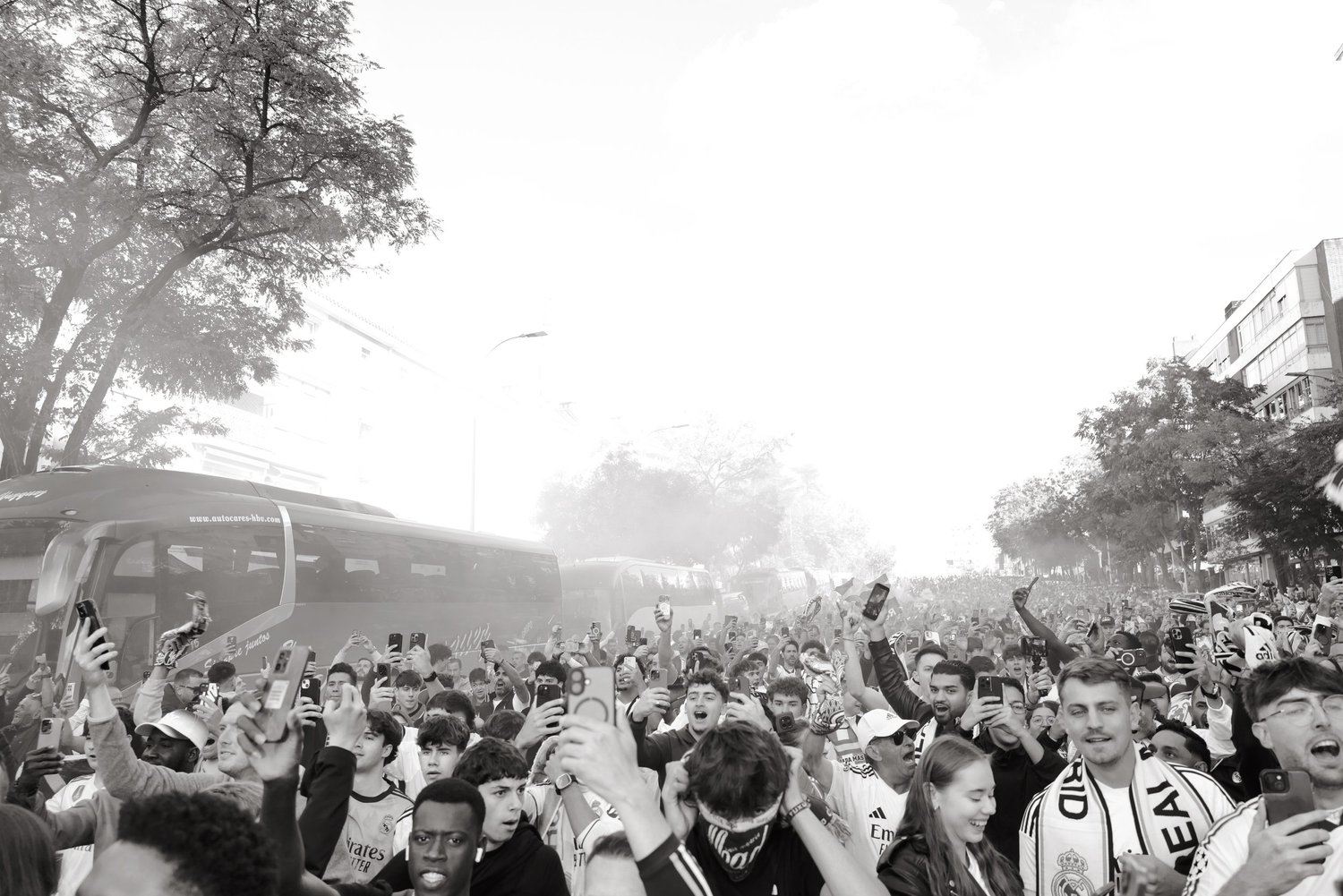 A dense crowd of football supporters fills the street