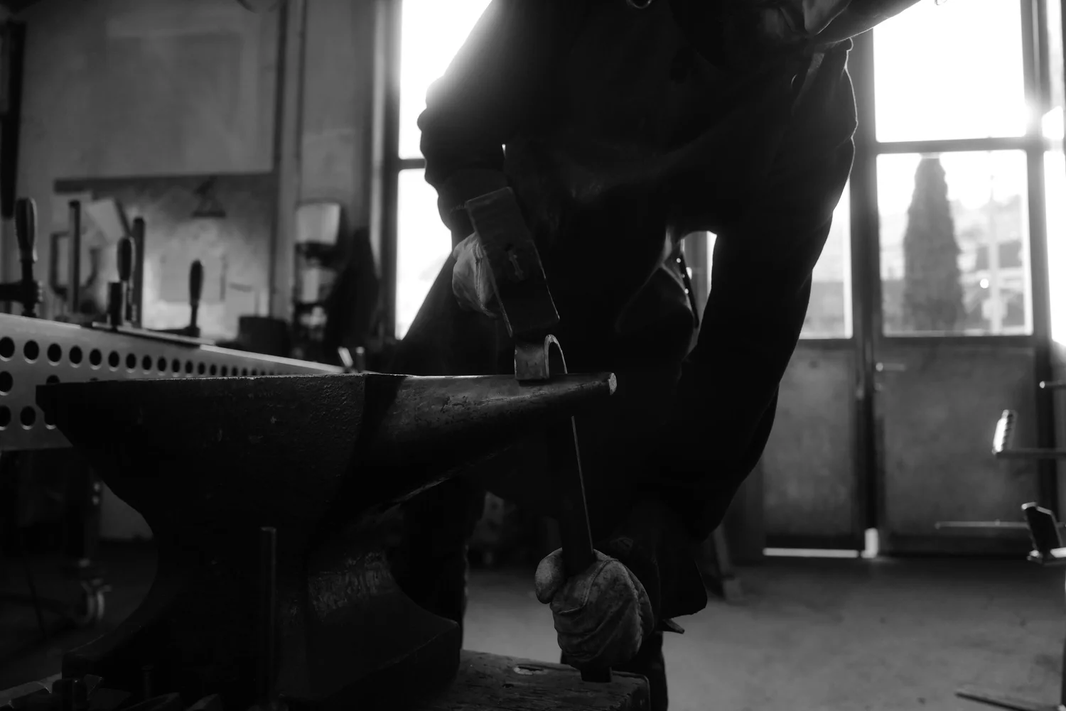 Hands, hammer and anvil at Kraftschmiede