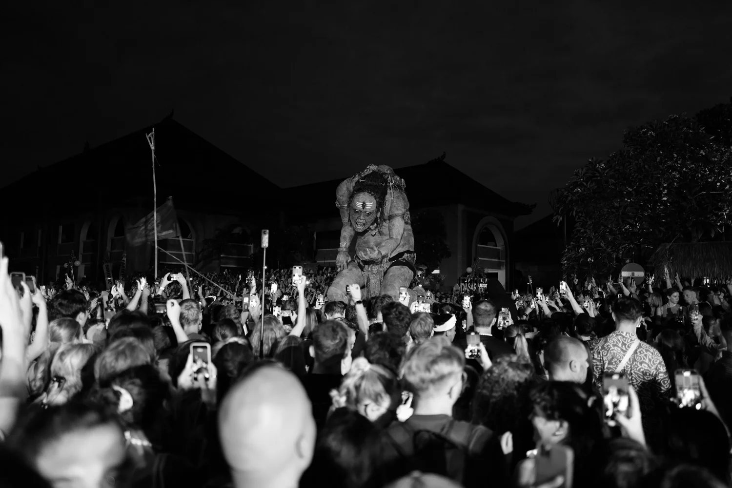 An Ogoh-Ogoh figure above the nighttime crowd