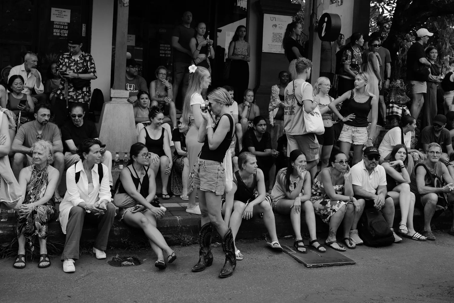 Spectators waiting on steps beside the procession