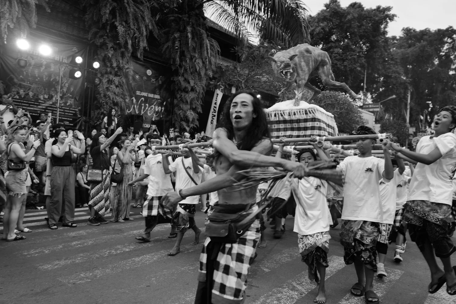 Carriers and a tiger figure in the moving procession
